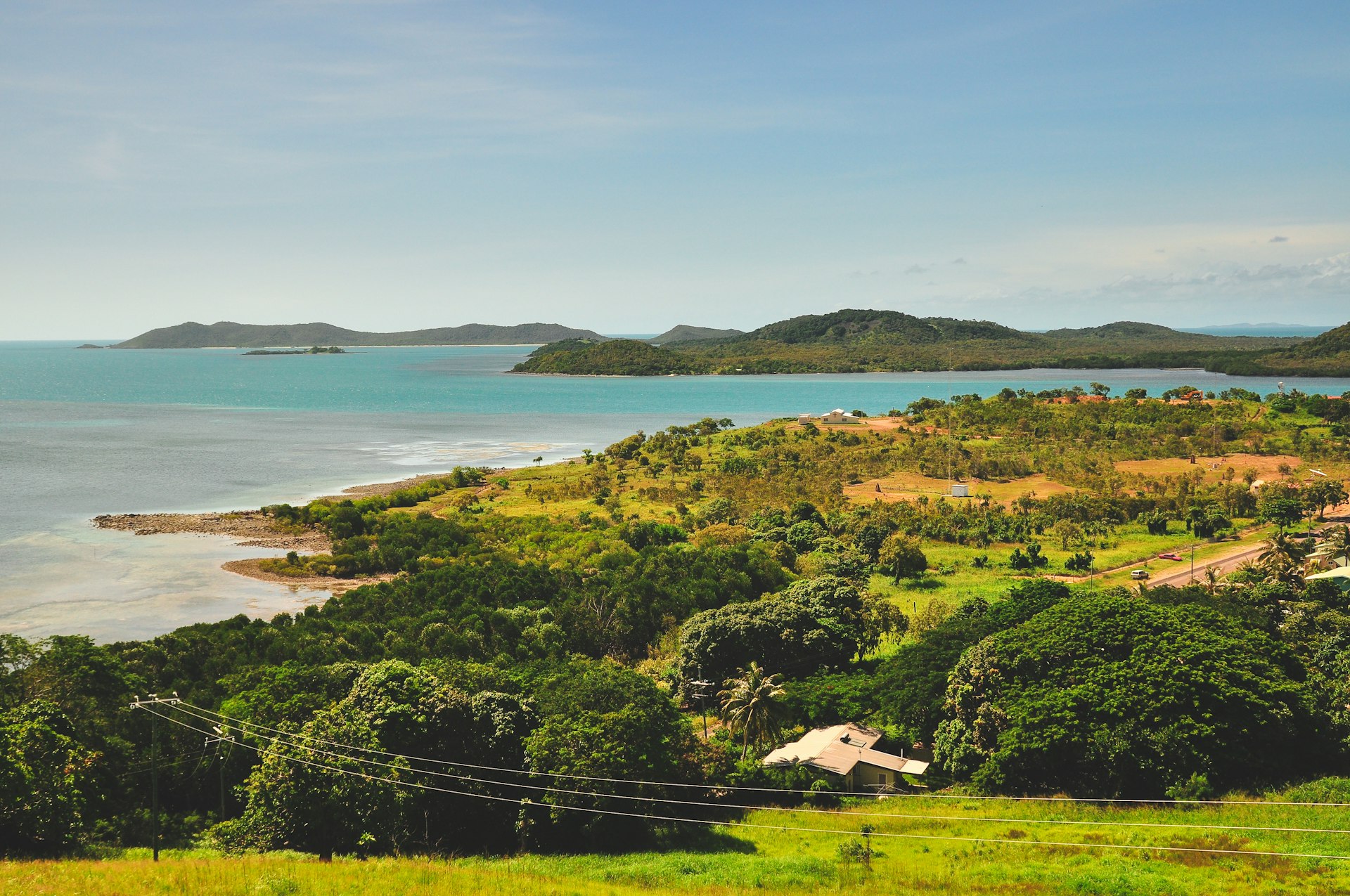 A lush island covered in greenery with beautiful beaches lapped by a turquoise ocean