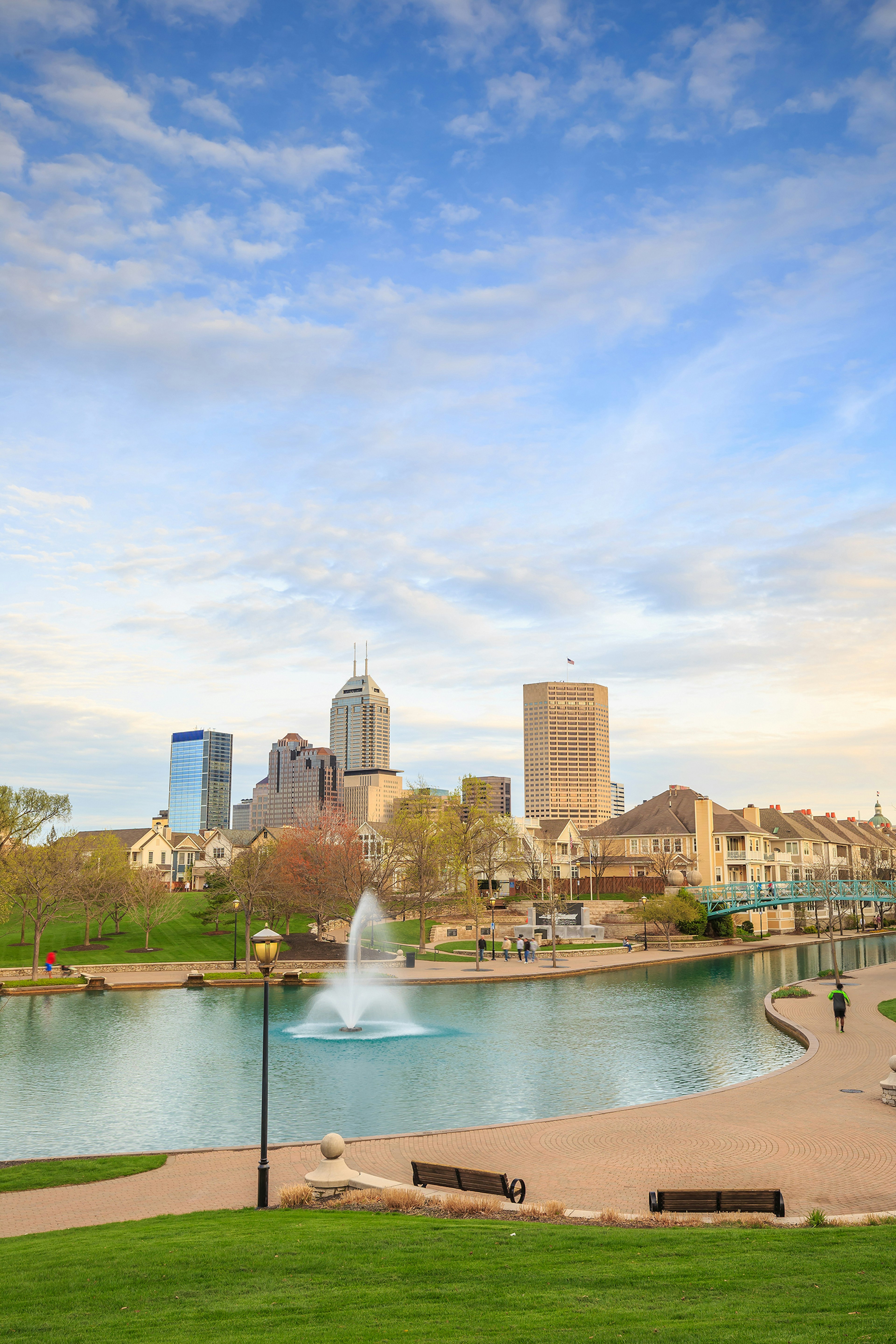 wide view of the Indiana Central Canal with skyscrapers in the background on a sunny day © f11 photo / Getty Images