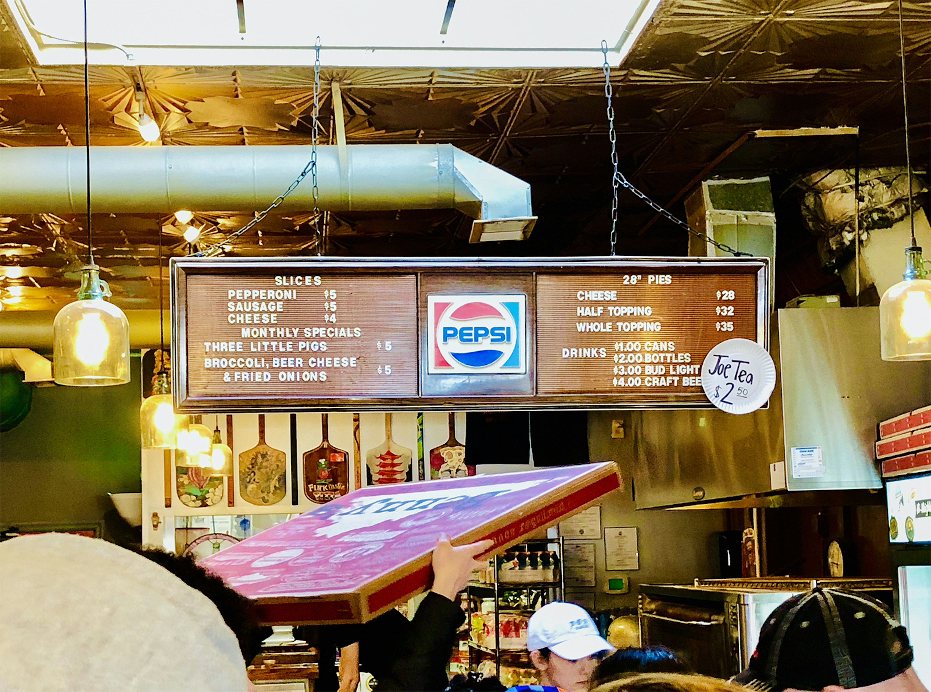 Interior shot of a high-ceilinged building with tin ceiling tiles