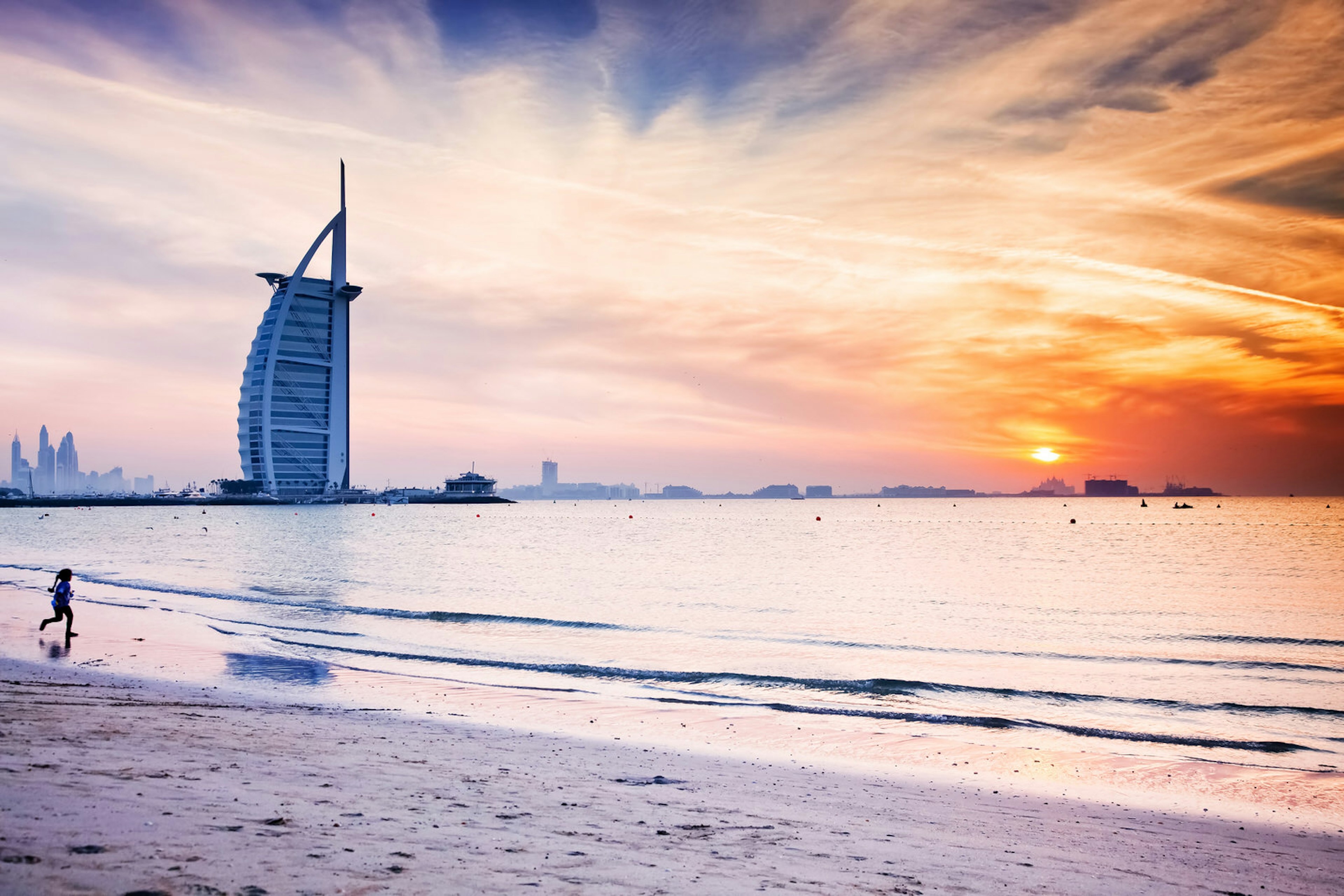 The world's first seven stars luxury hotel Burj Al Arab at sunset seen from Jumeirah public beach in Dubai, United Arab Emirates