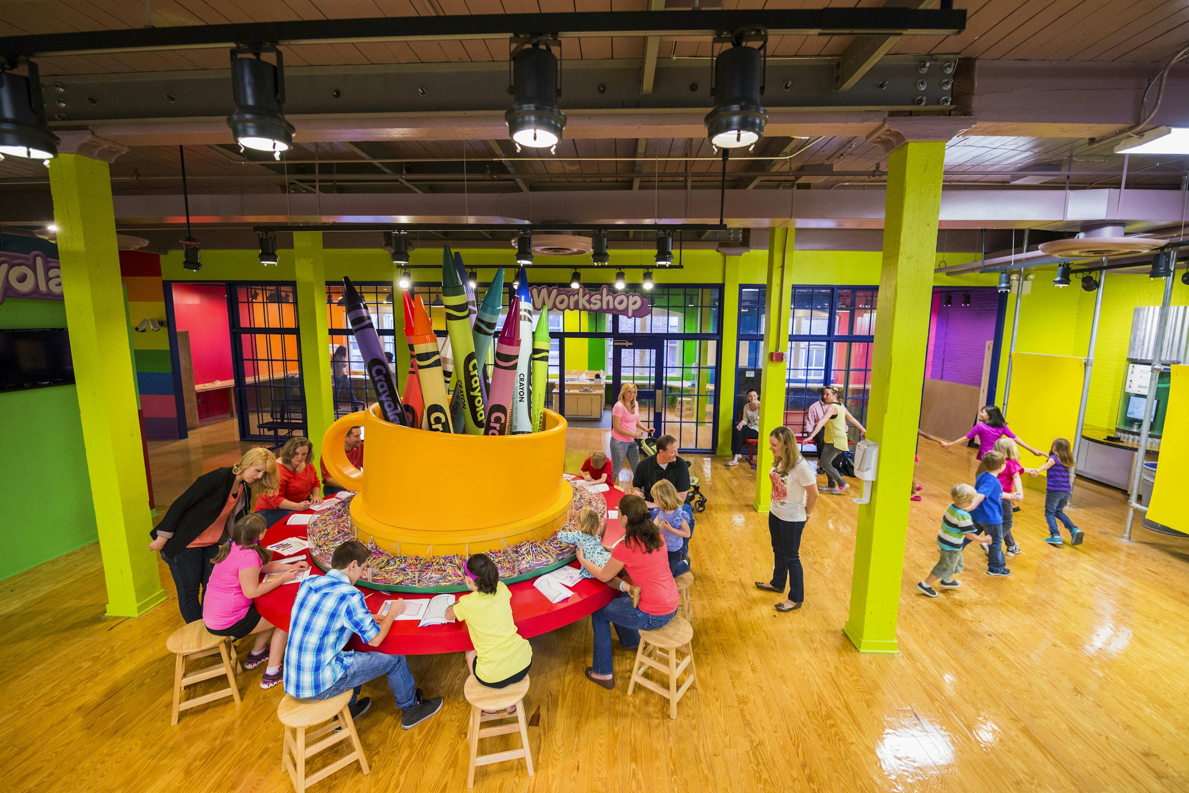 Children color with crayons in the Crayola workshop