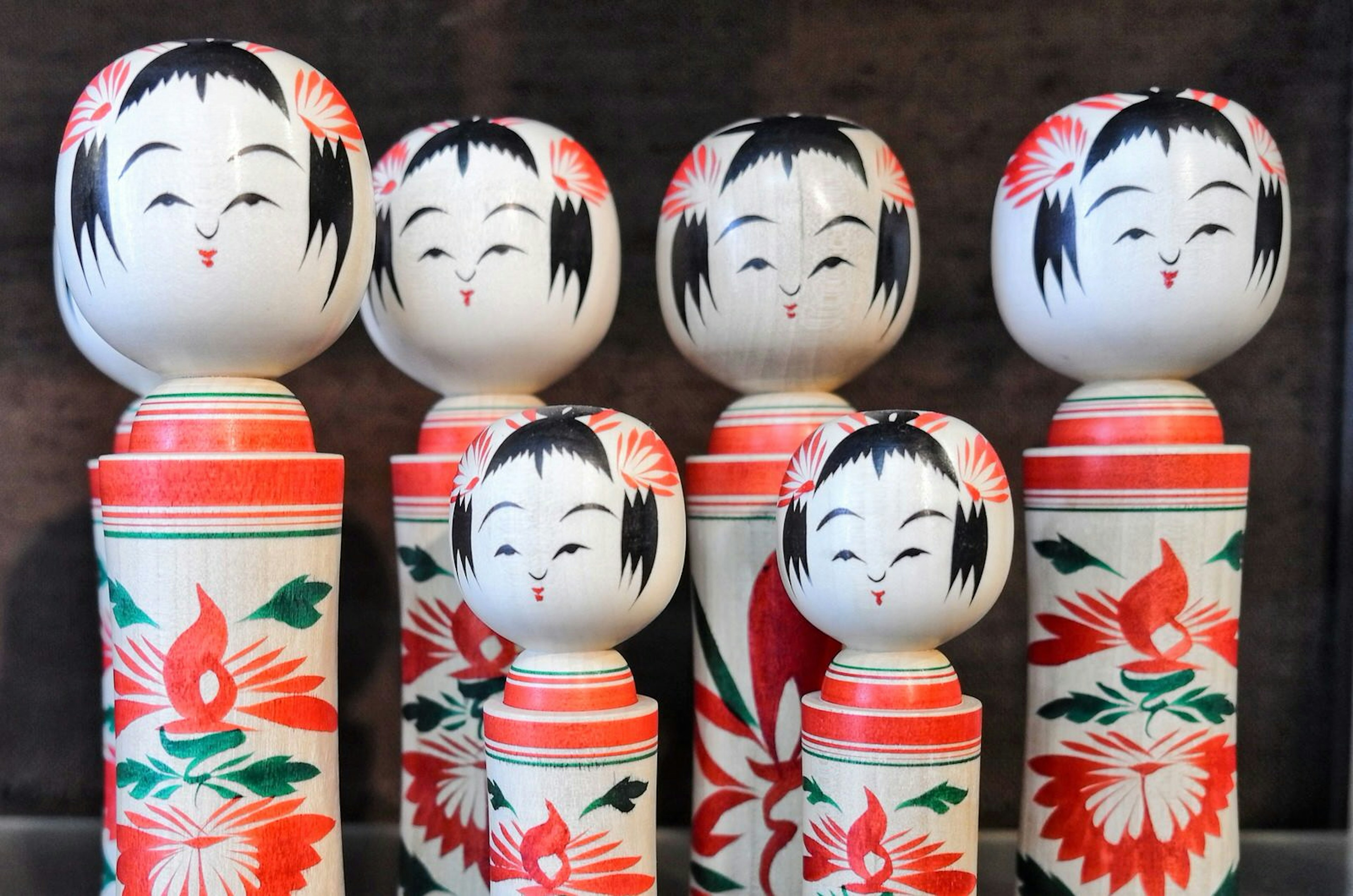 A collection of finished kokeshi with painted faces and chrysanthemum motifs on the body © Manami Okazaki / Lonely Planet