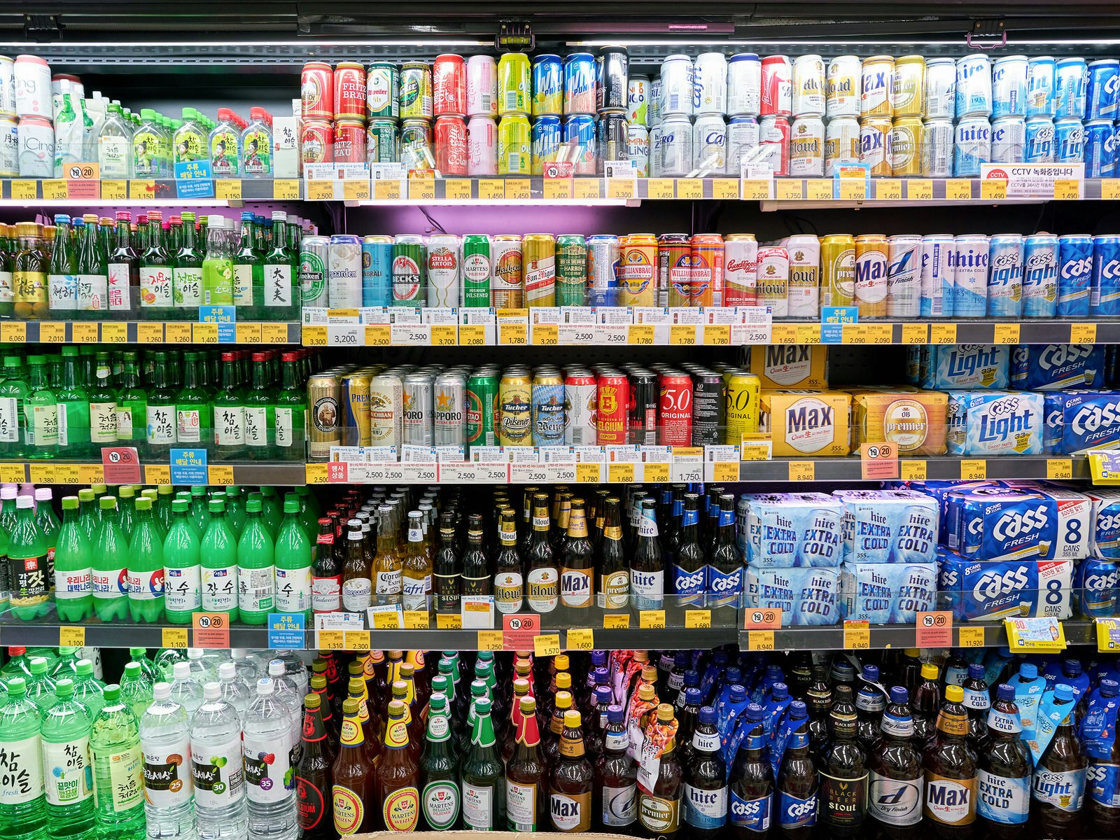 A fridge full of multi-coloured bottles of soda, beer and soju. Convenience stores like CU (pictured) a popular party spots and a good place to drink on the cheap © Sorbis / Shutterstock