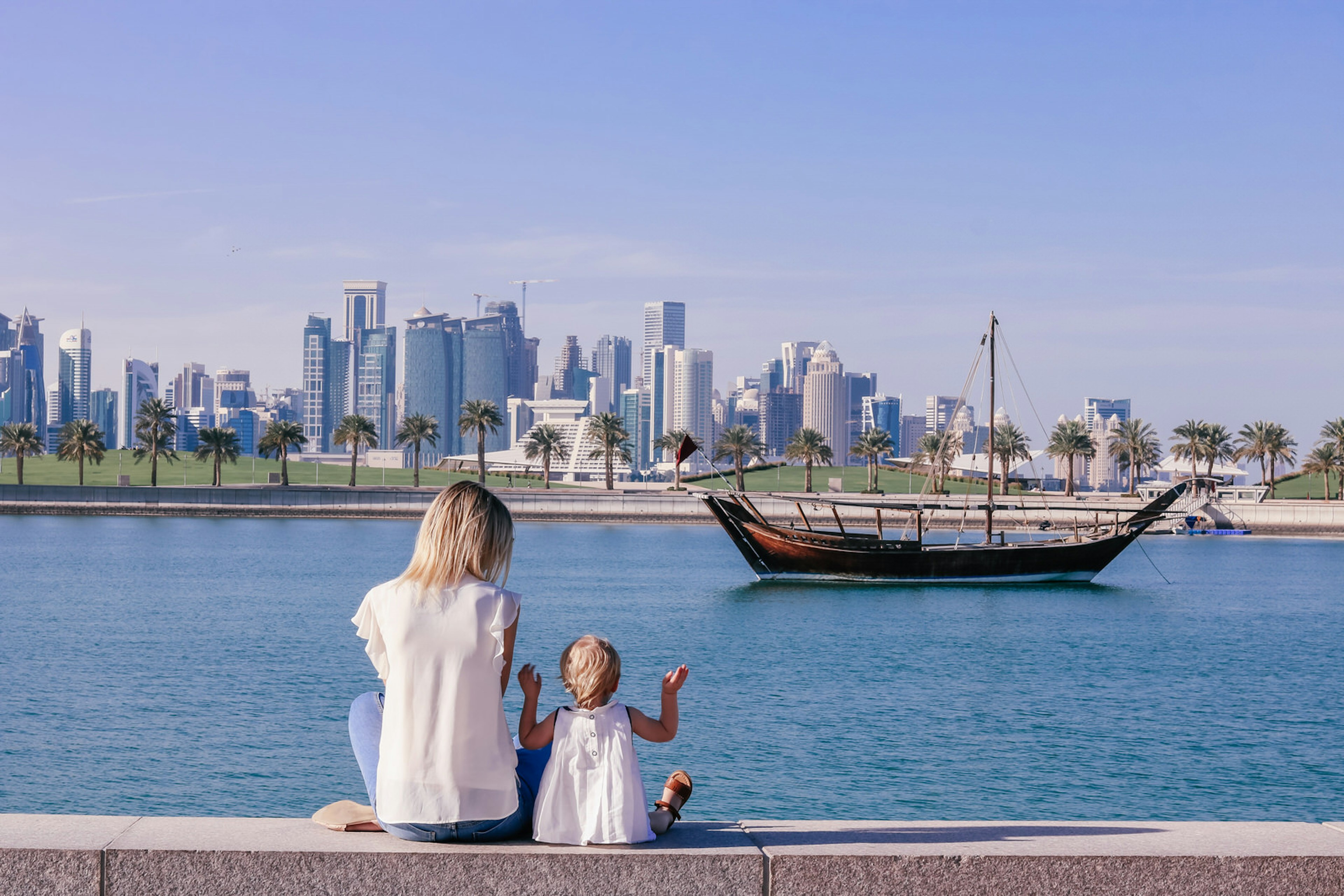 Polly and her daughter watch dhows sail past in Doha's harbour © Polly Byles / iBestTravel