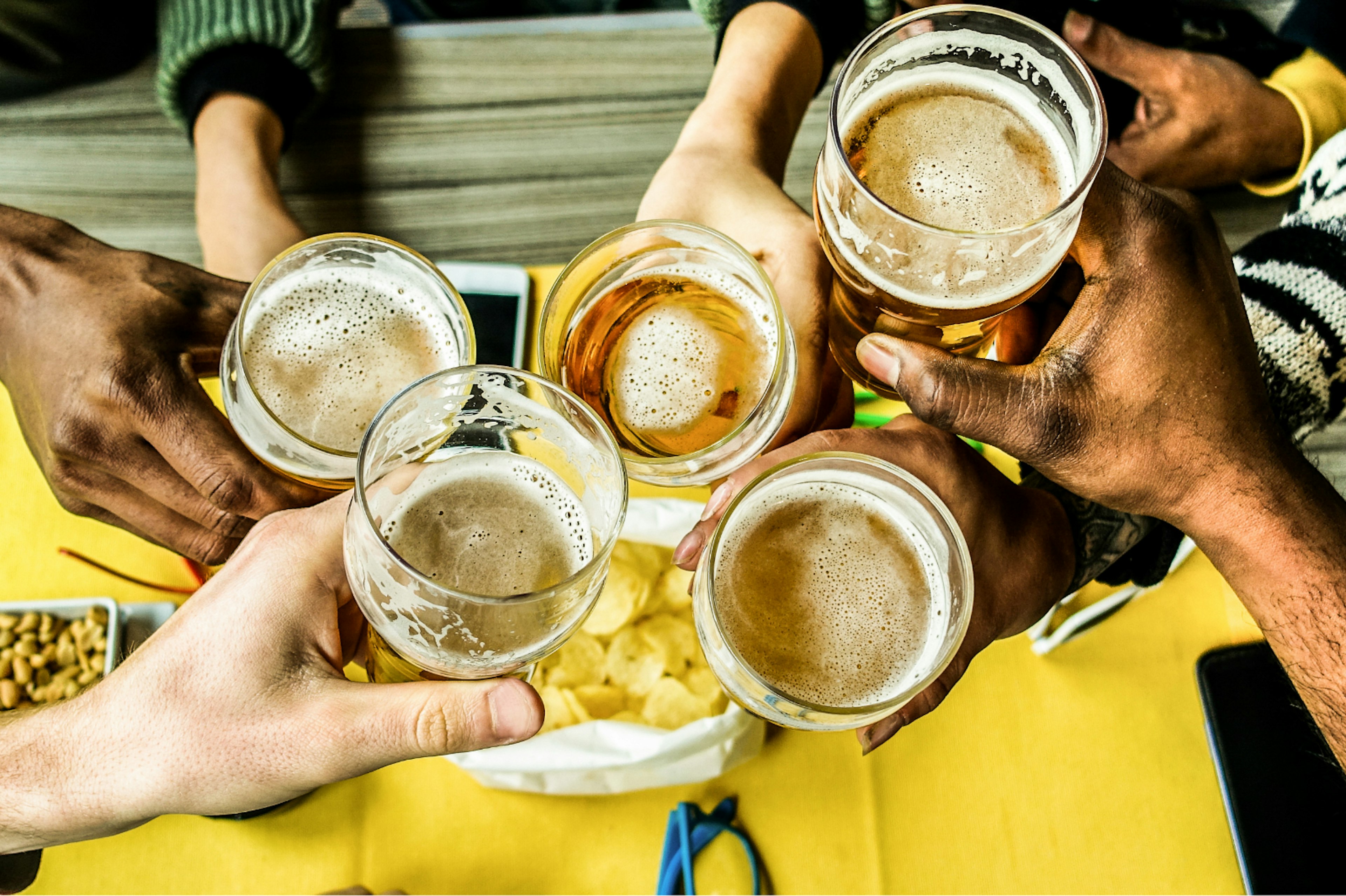 A close up of pint glasses mid-'cheers'