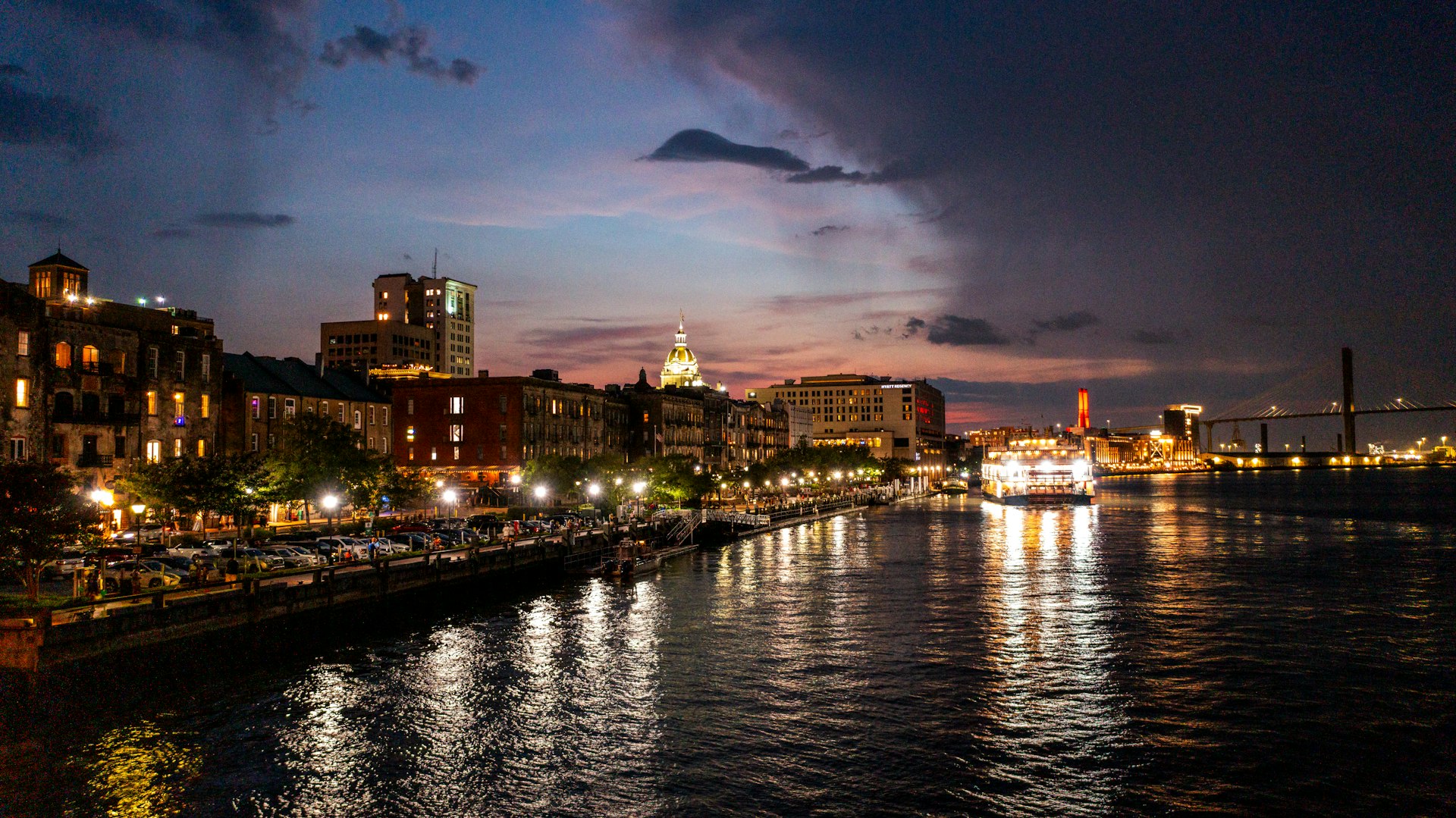 A view of the lights on the buildings on River St by the Savannah River at dusk, Savannah, Georgia