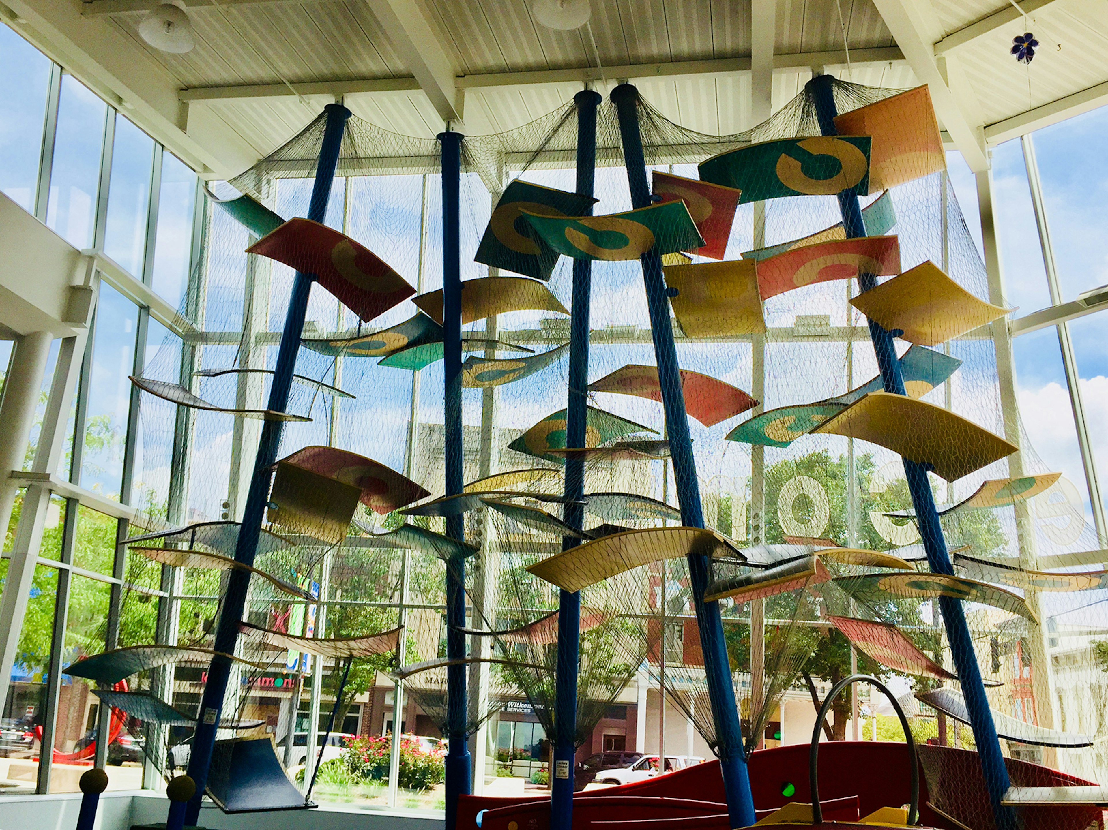 indoor climbing gym covered in protective netting, surrounded by glass windows in Columbus Indiana