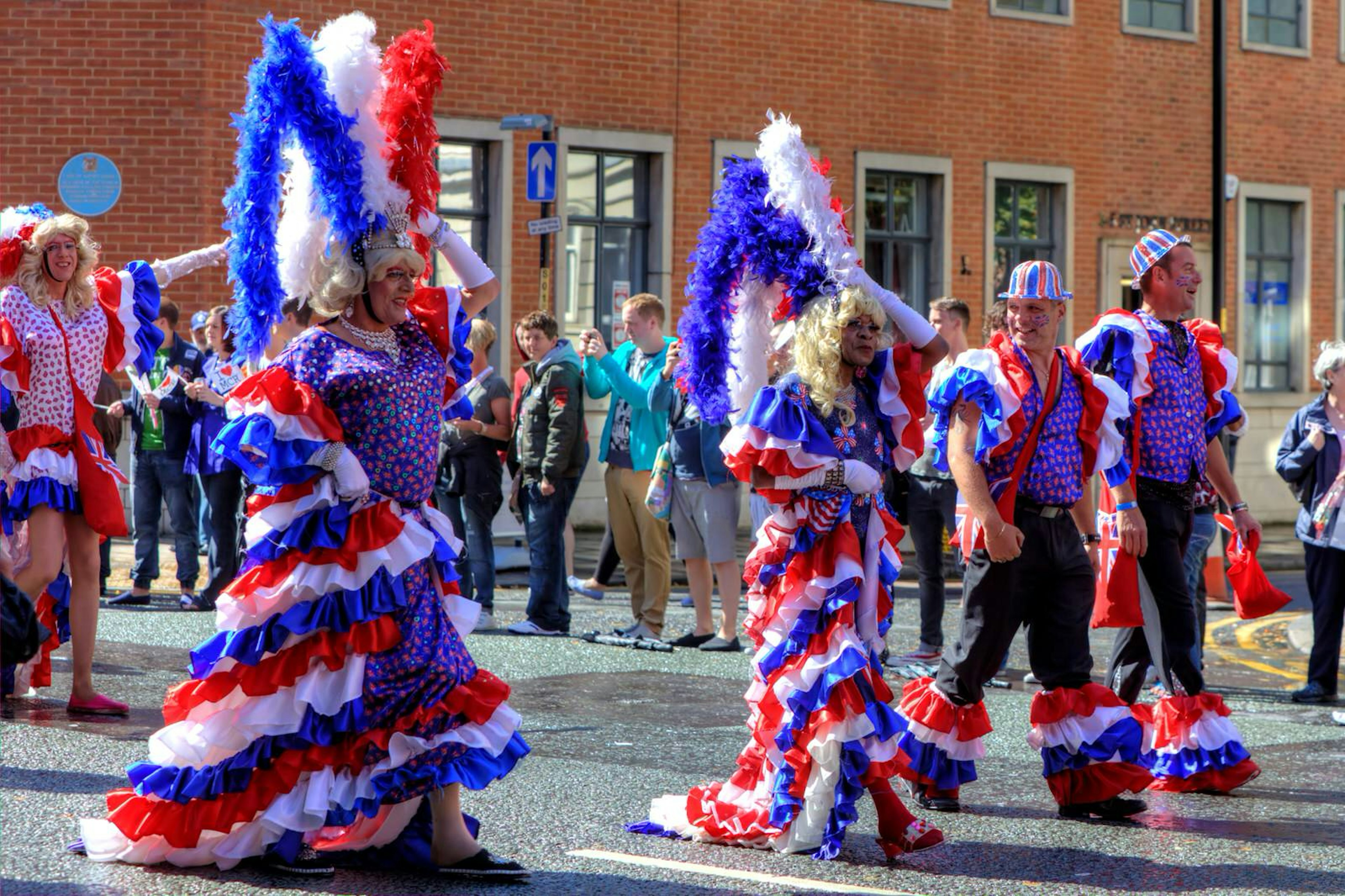 Parade participants in red, white and blue costumes at Manchester Pride in the UK