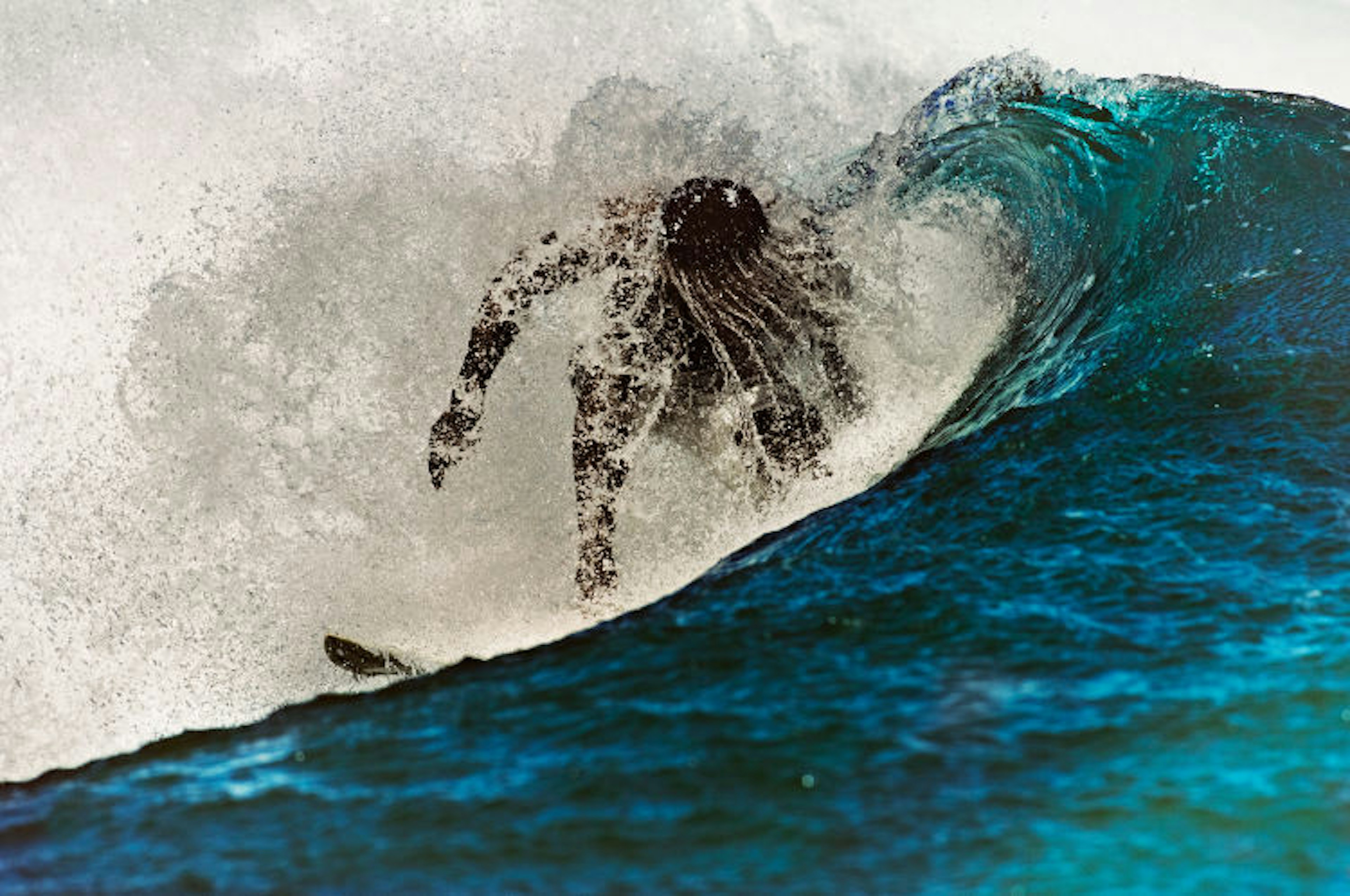 Surfing along Le Morne Peninsula, Mauritius. Image by Alberto Guglielmi / Getty Images