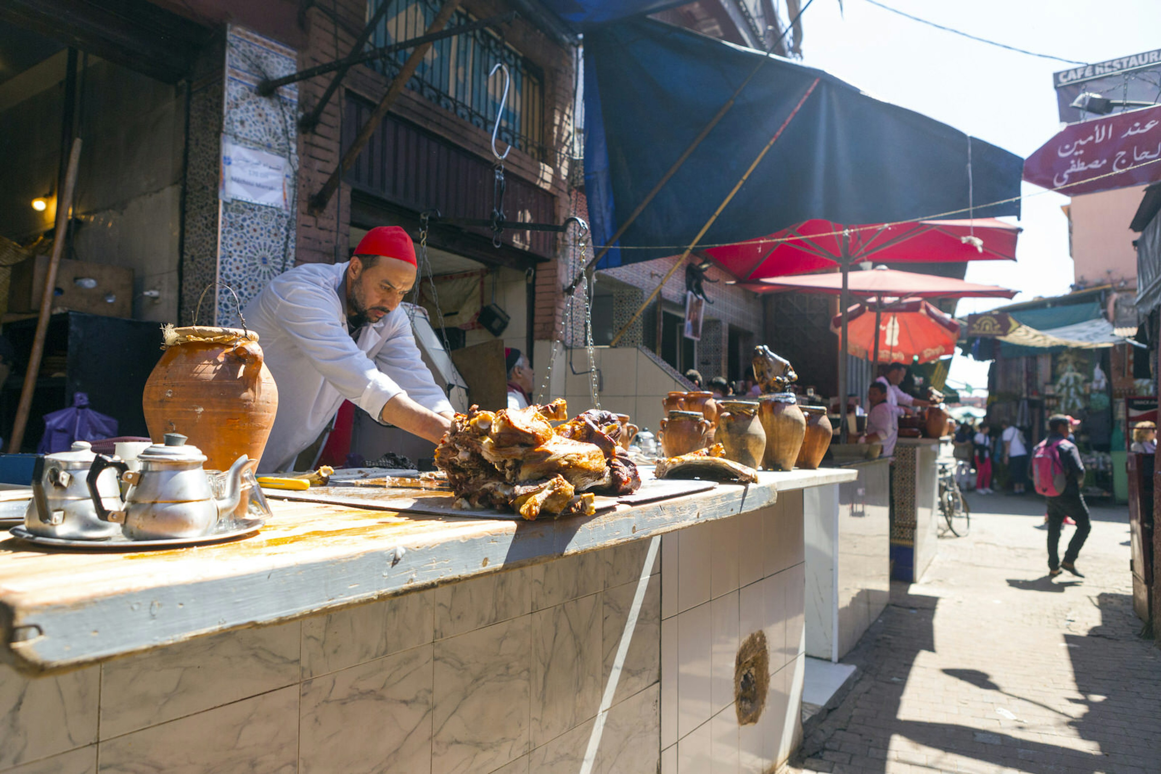 Vendor selling slow-roasted lamb along Marrakesh's 'mechoui alley'.