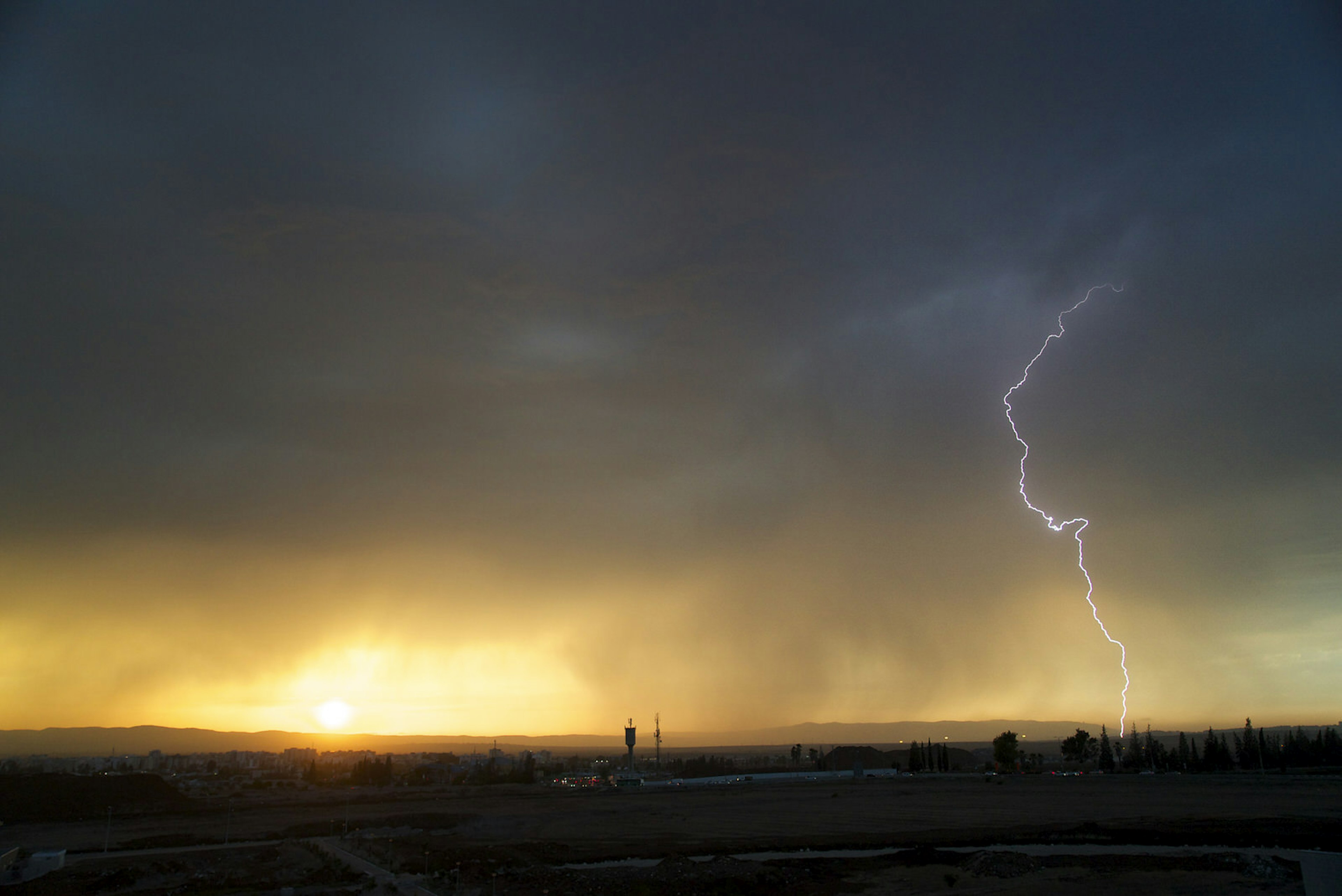 Lightning strike at sunset over the Jezreel Valley and Megiddo in Israel. Image by pronto8000 / Getty Images