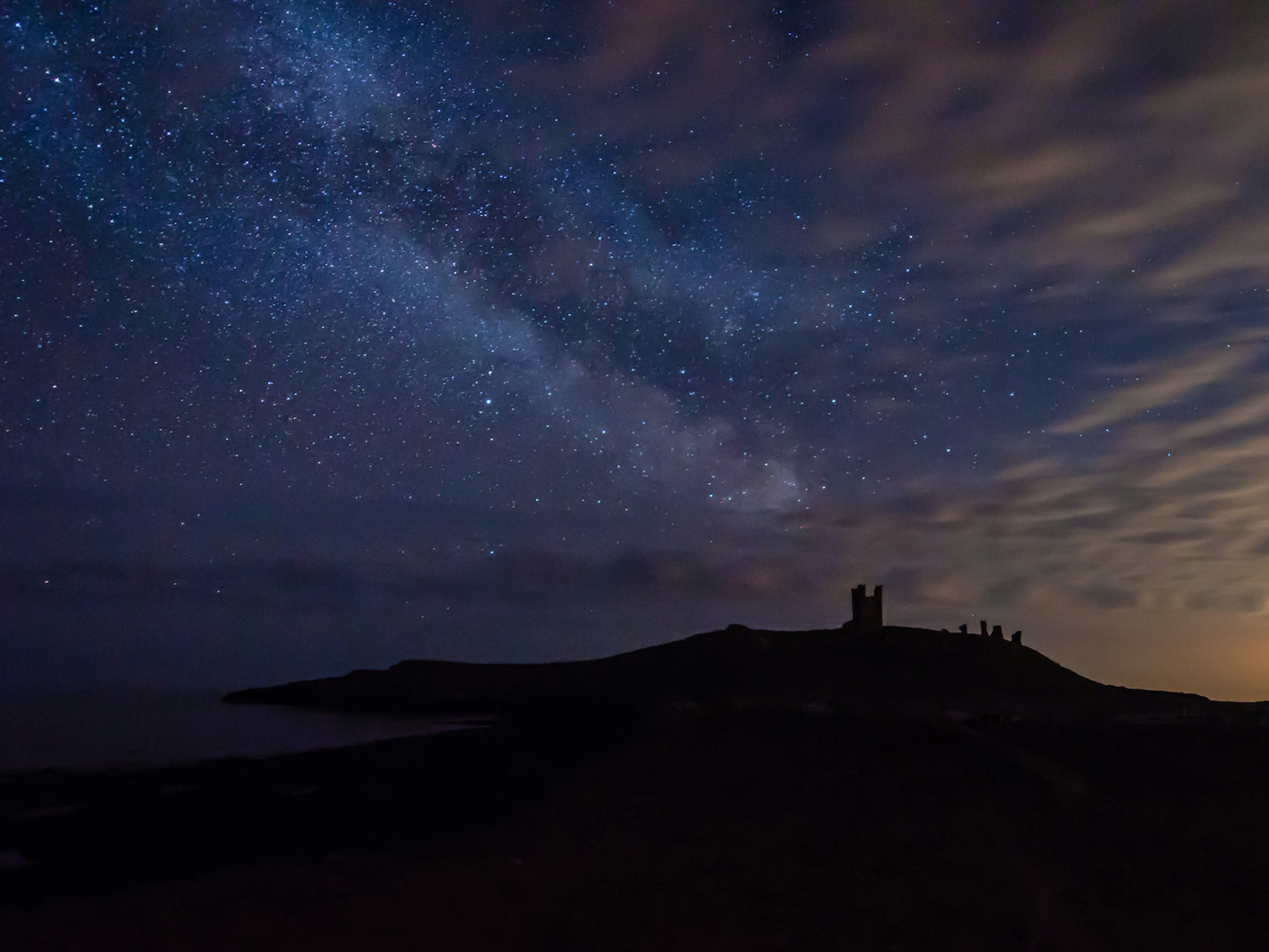 The night sky at Dunstanburgh Castle in Northumberland National Park, an IDA-designated dark sky park