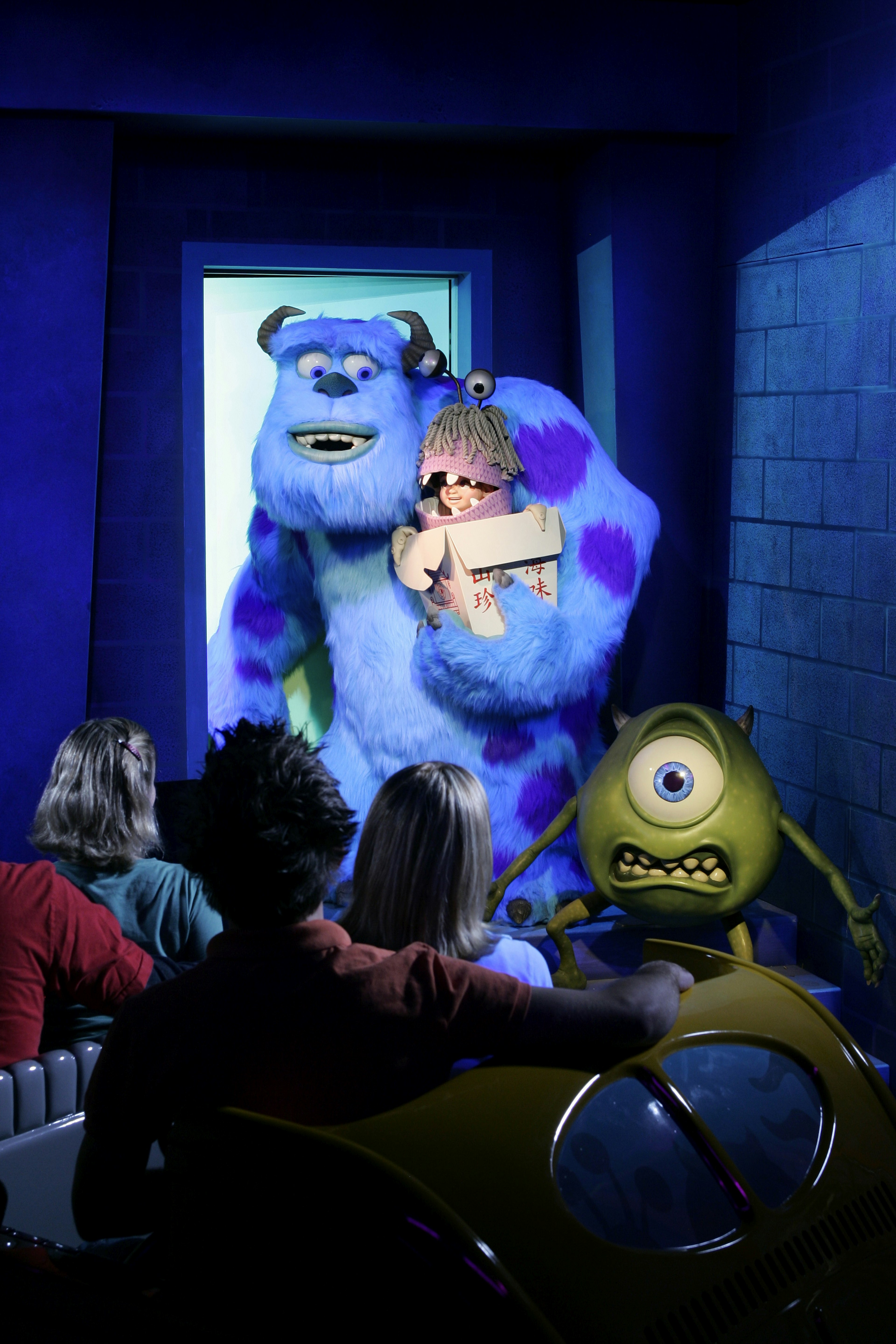 Animatronics of Mike, Sulley and Boo with guests in the foreground looking up at them