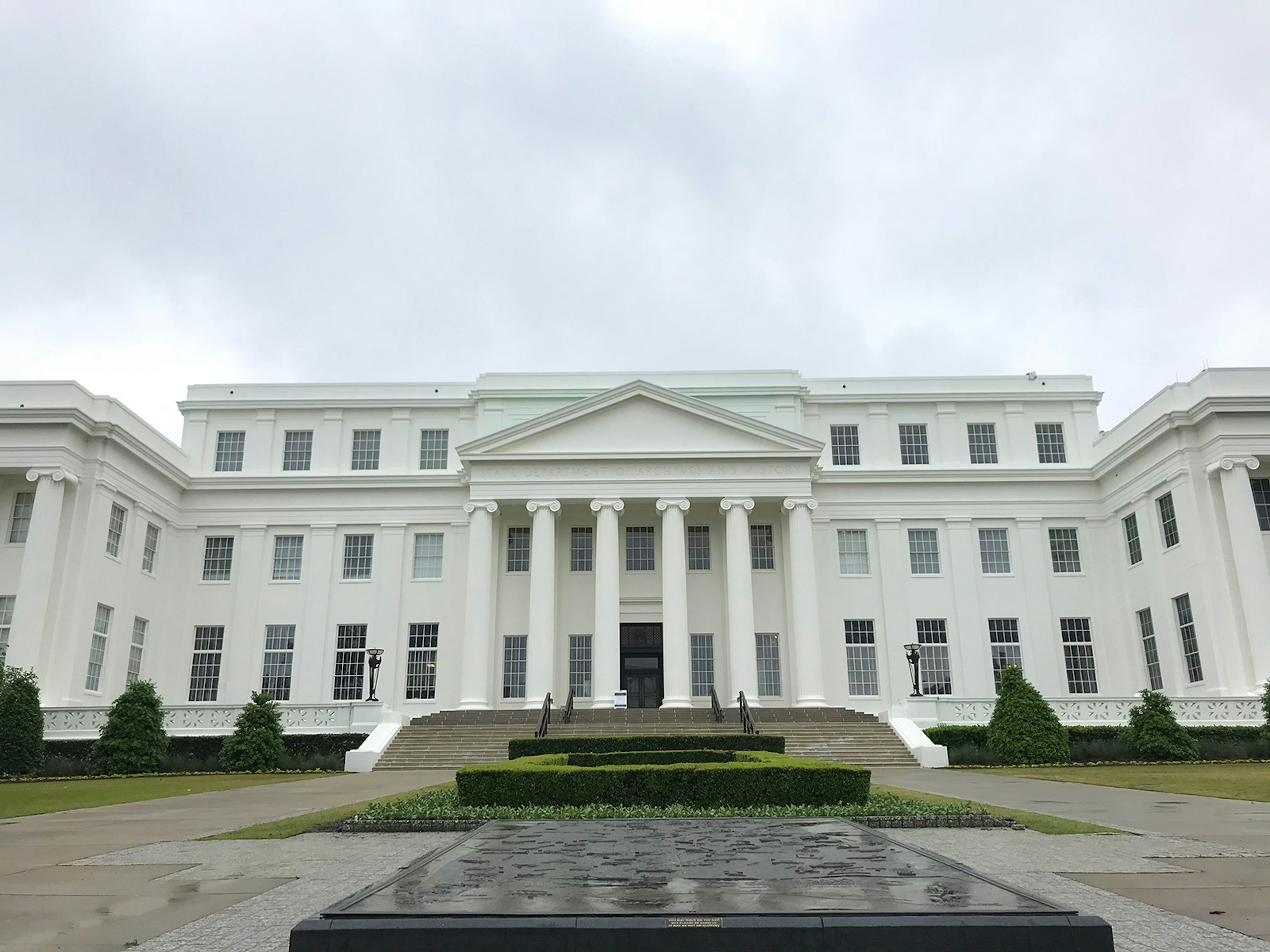 Front exterior of the Museum of Alabama, a large, white, Greco-Roman inspired structure with ionic columns © Carla Jean Whitley / Lonely Planet