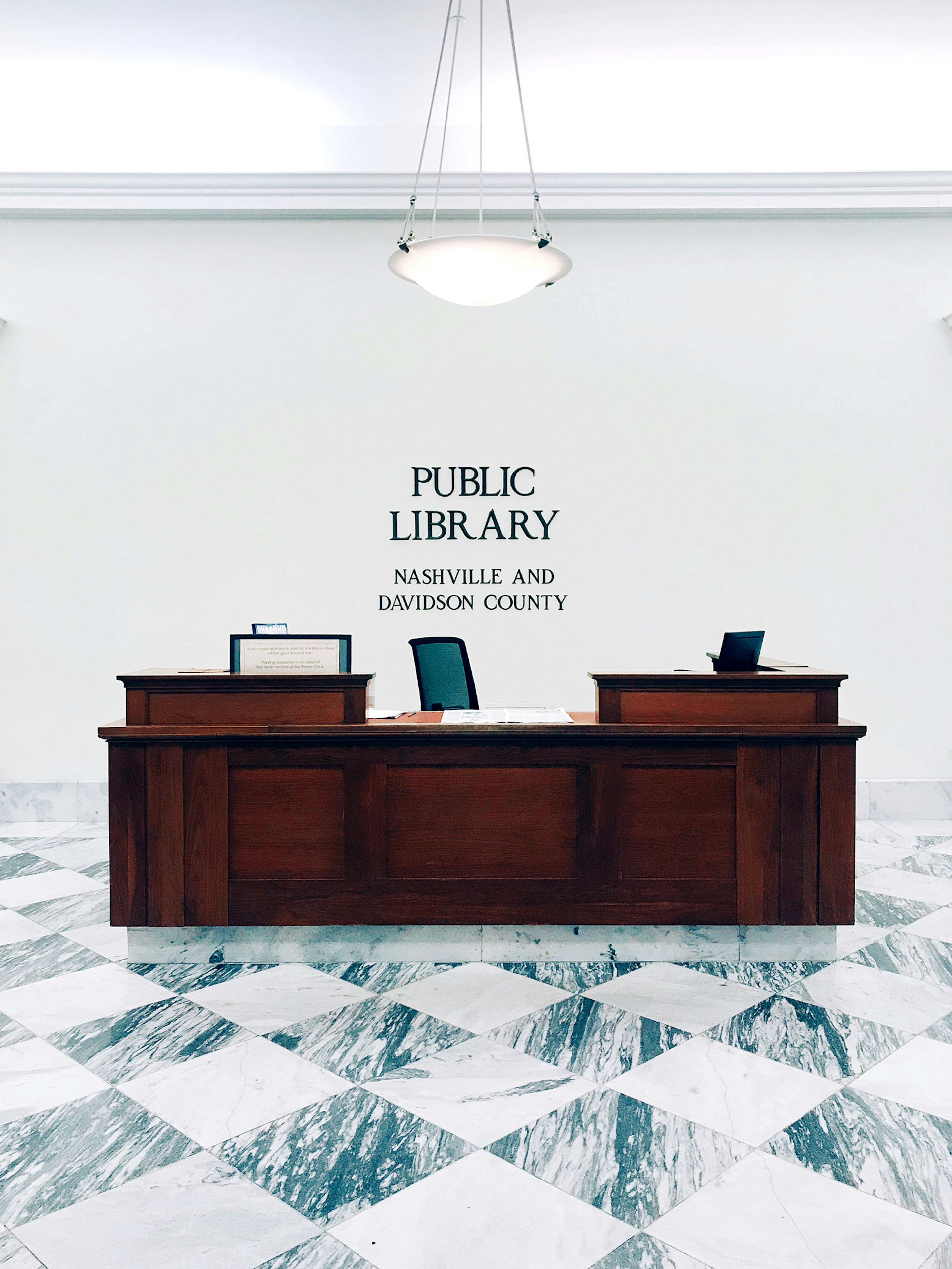 travertine floors and a wooden front desk at the downtown Nashville Public Library