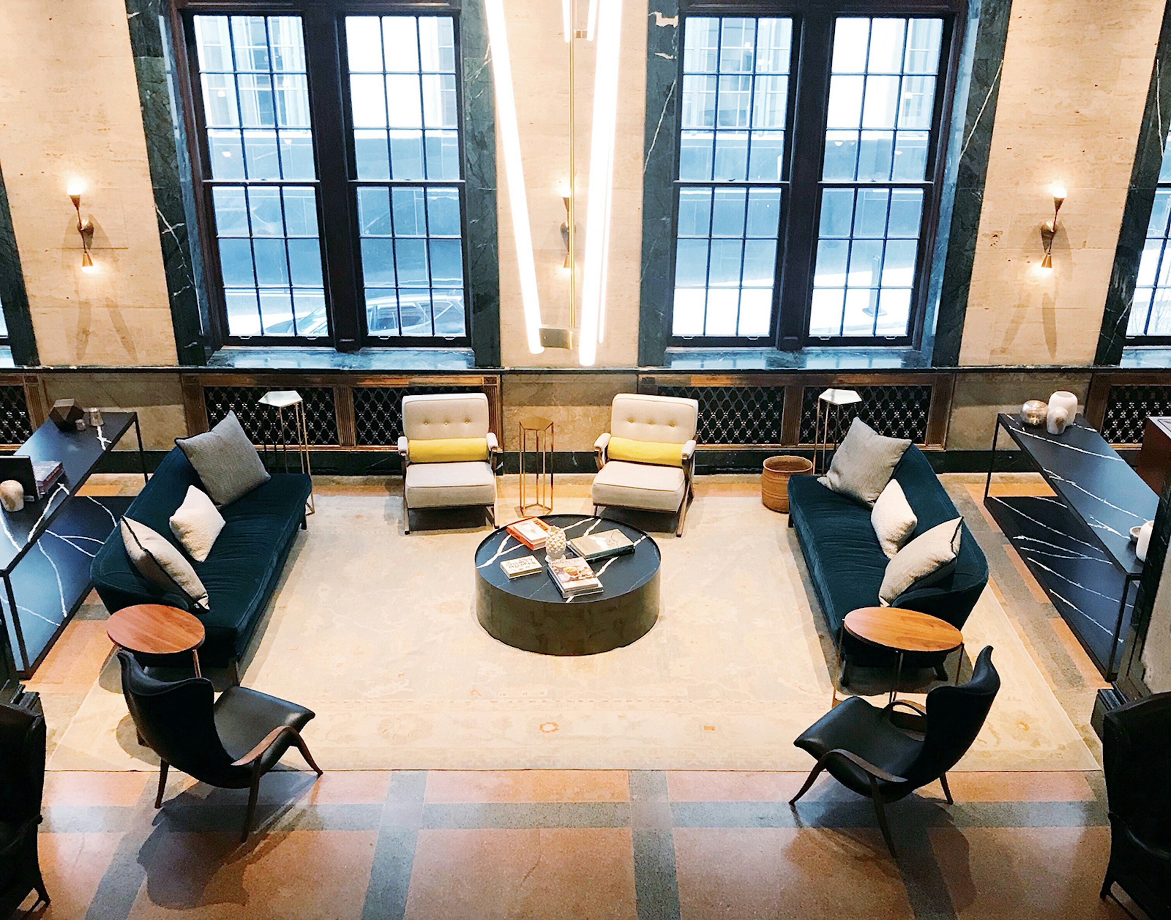 aerial view of a hotel lobby with travertine floors, marble walls and two large windows. Veer away from downtown Nashville to experience some true gems.