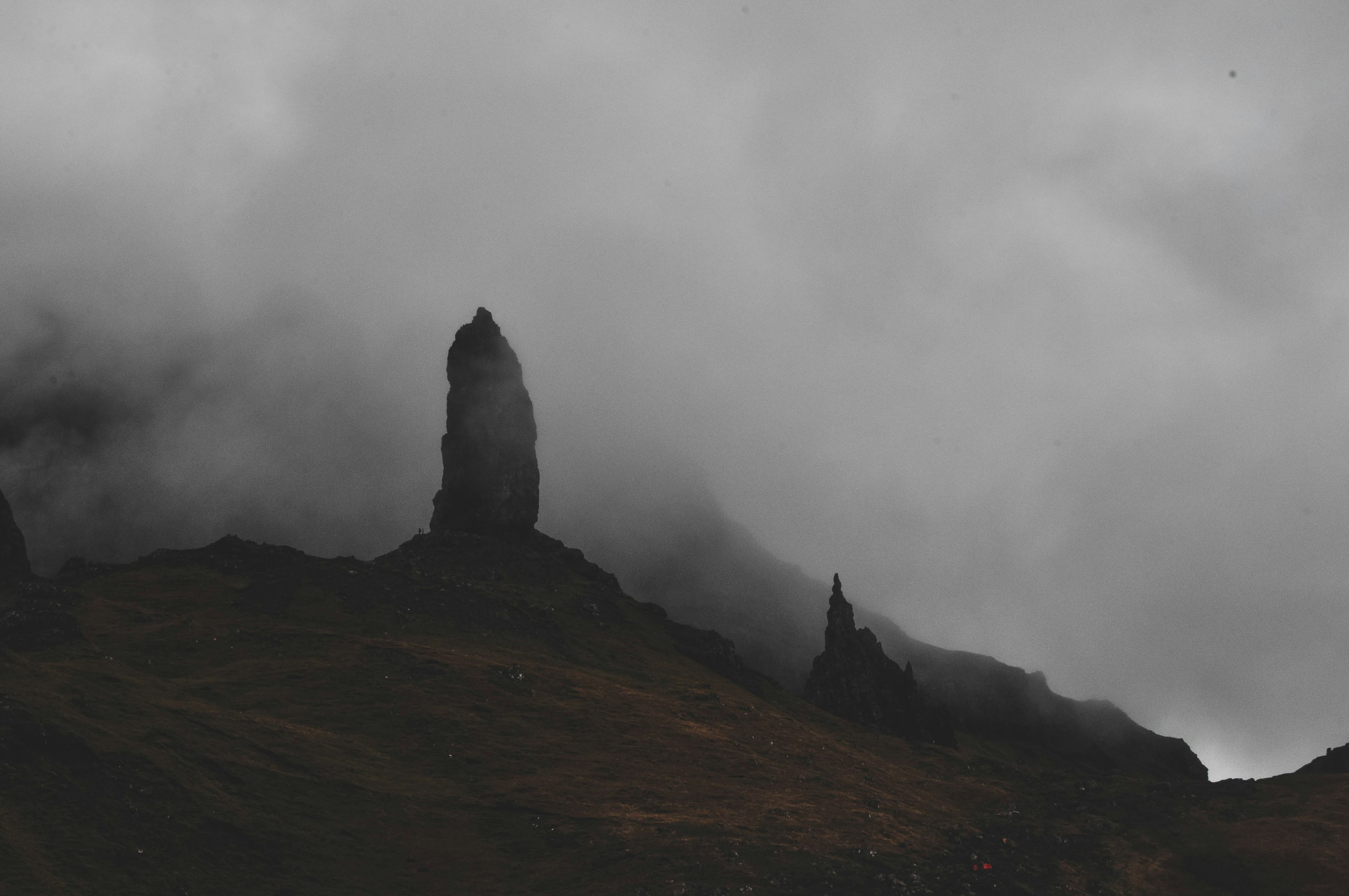 Rocks emerge ghost-like from a thick layer of mist.