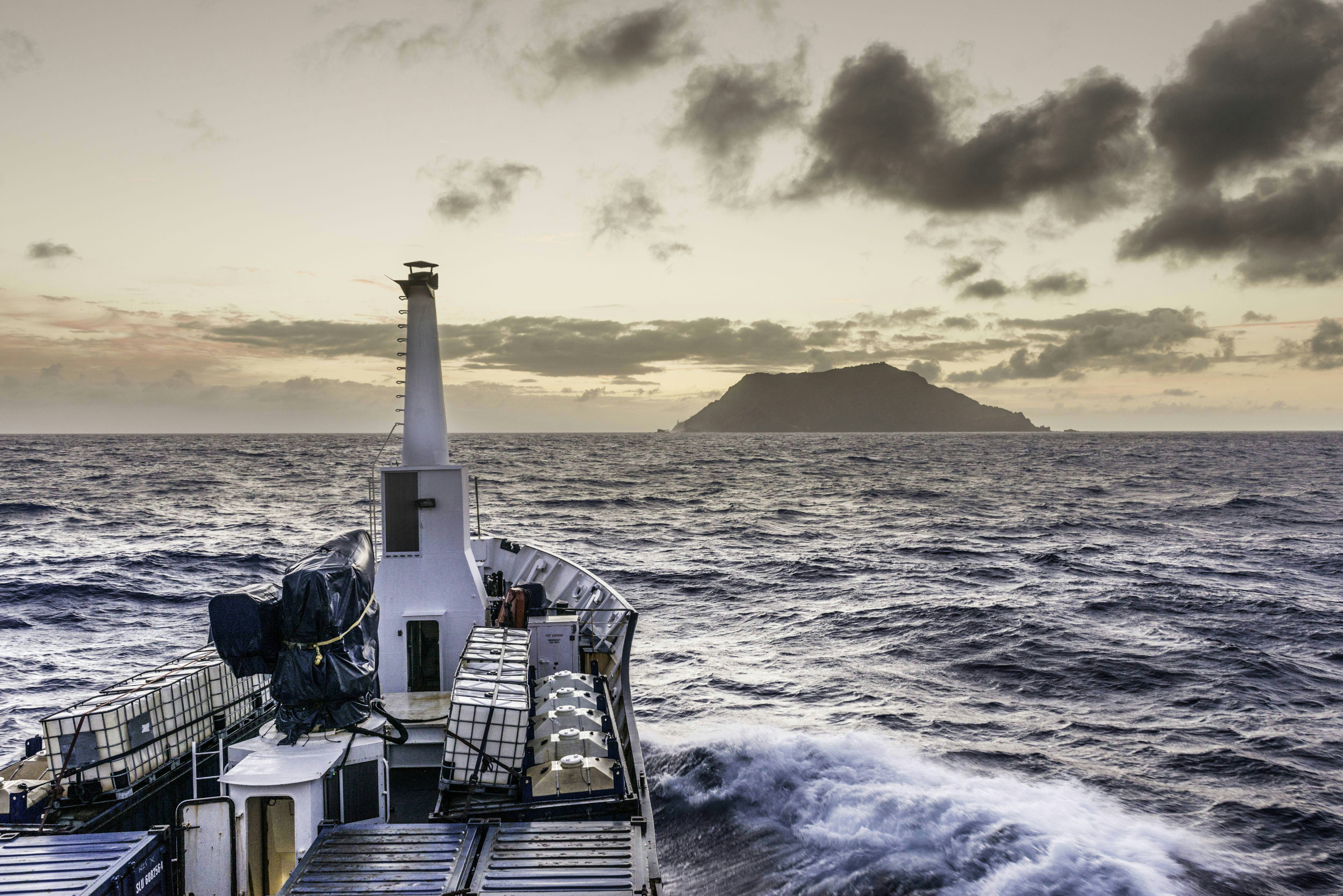 A freighter sails to a remote island