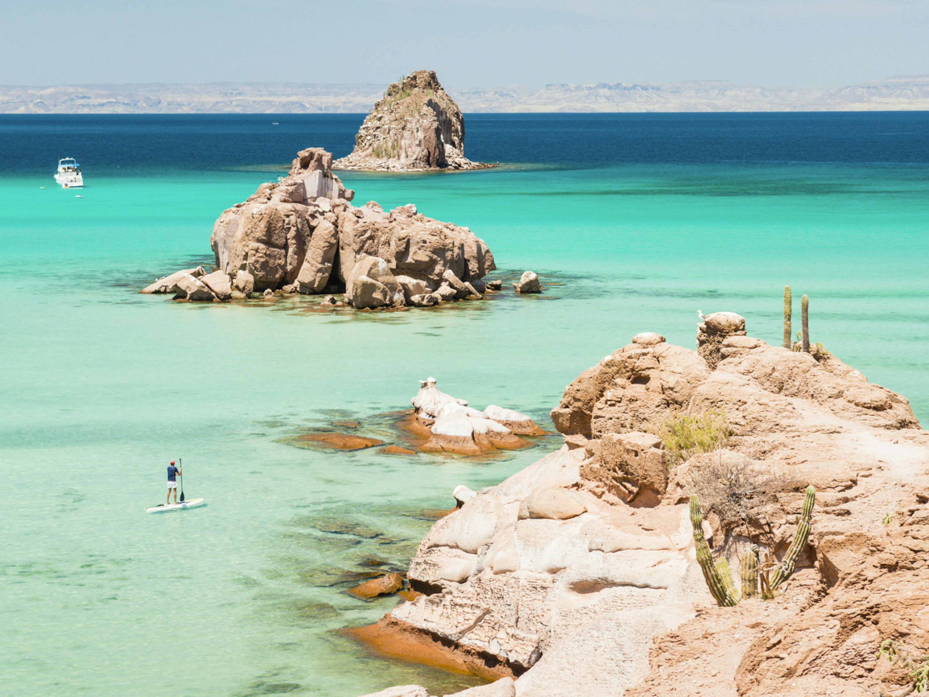 A paddleboarder exploring the bay around Espiritu Santo, La Paz