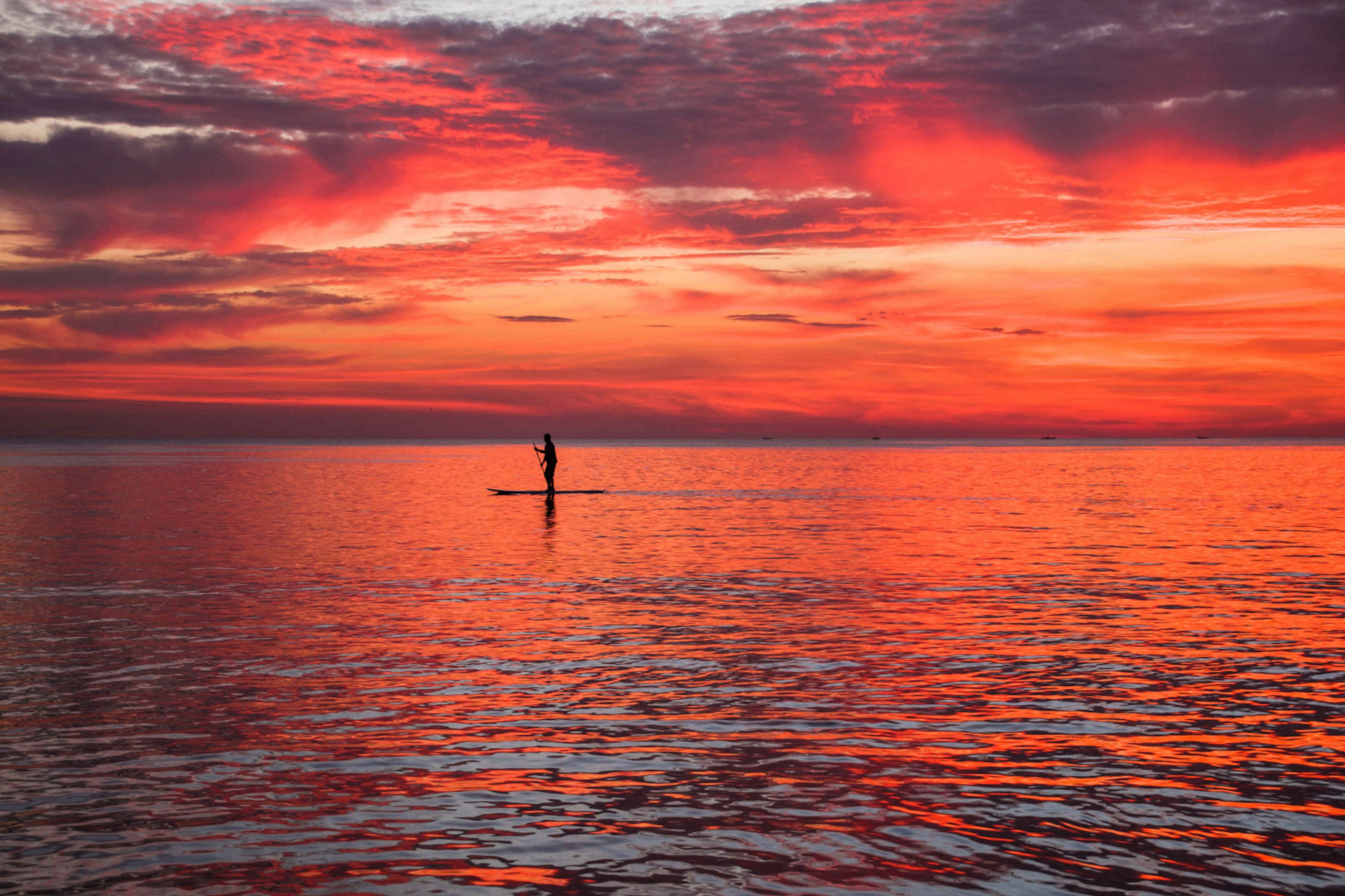 A paddleboarder in the sea at Palolem, Goa.