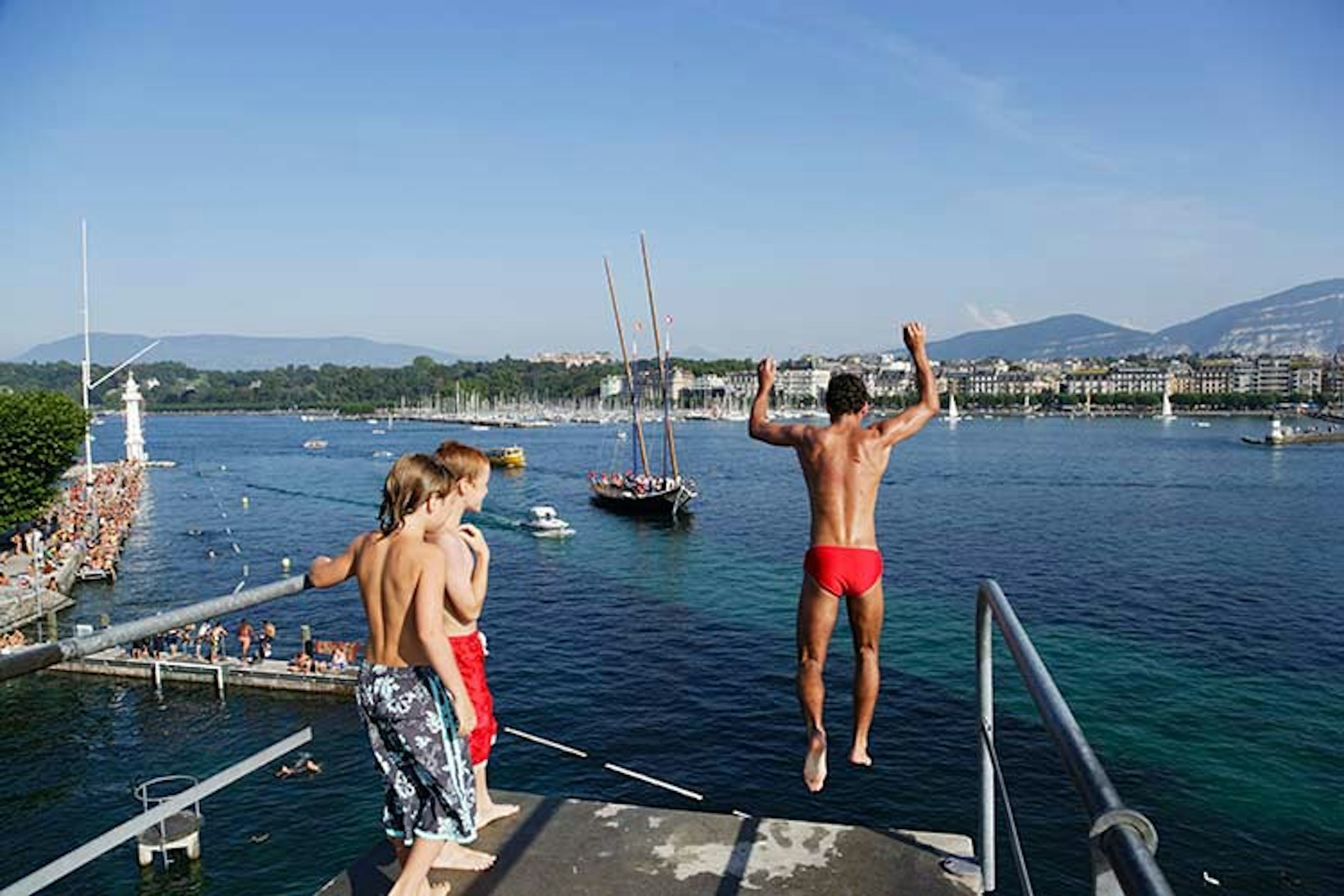 Swimmers jumping into the Bains des Pâquis. Image by Ingolf Pompe / LOOK / Getty Images.