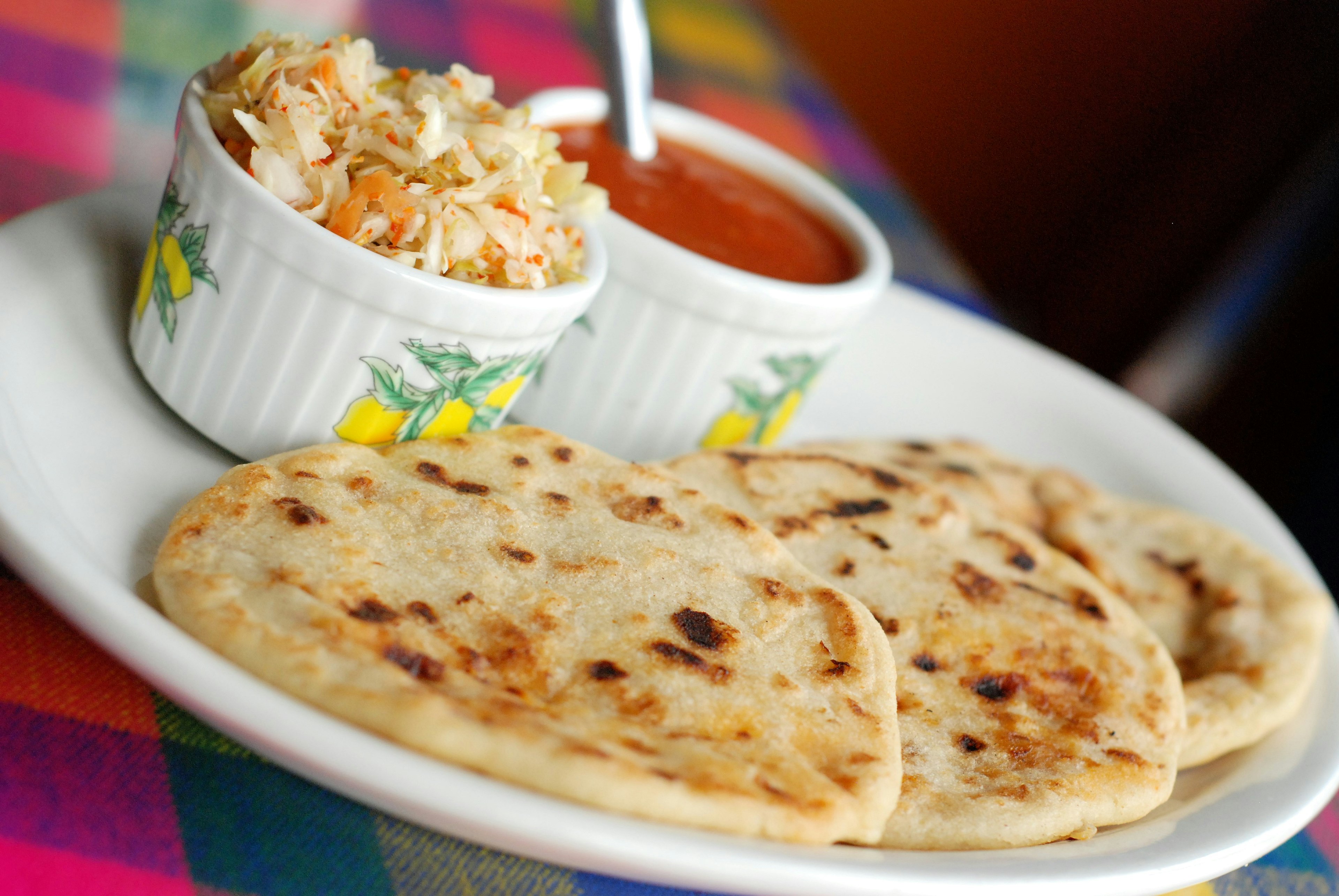 A fresh plate of pork and cheese pupusas