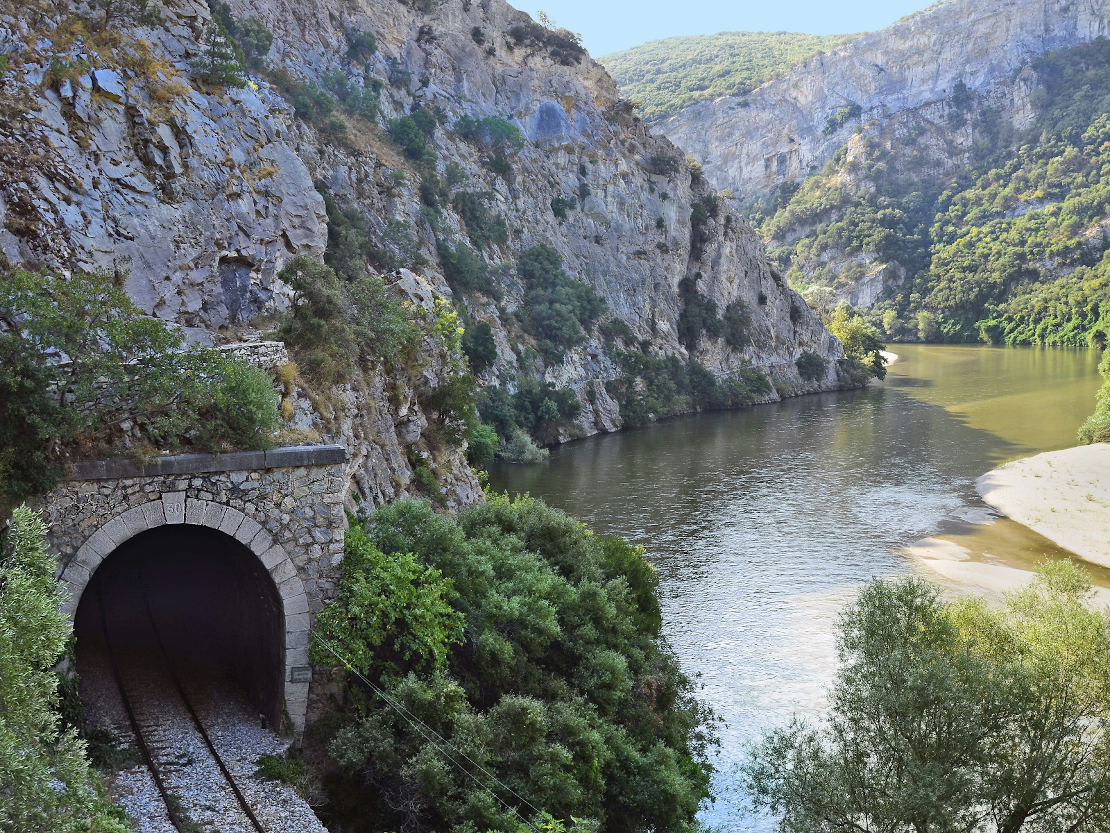 A tunnel and rails of the Drama-Xanthi train line along the Nestos river