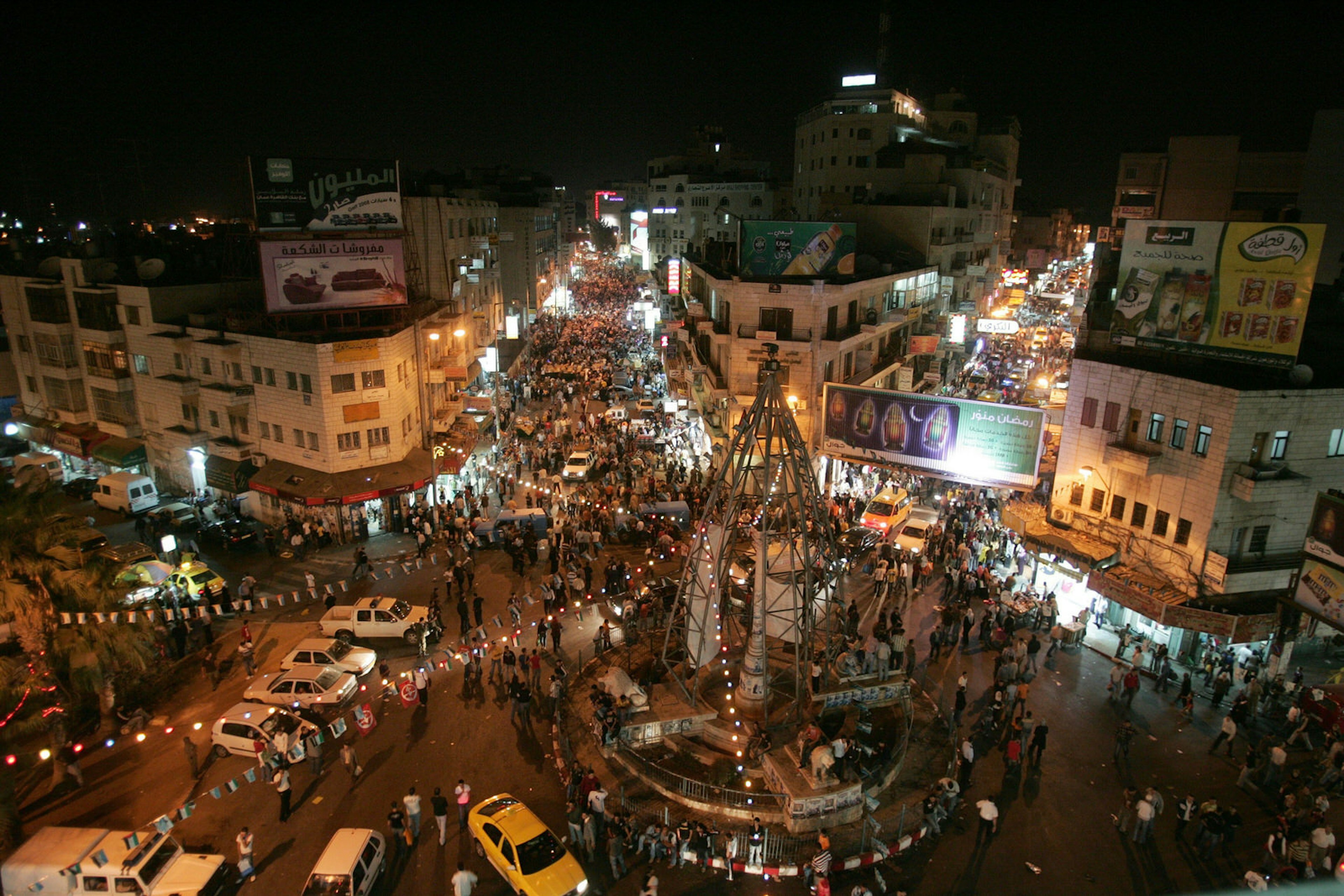 Night scene in the West Bank city of Ramallah, Palestinians in the streets at evening on the last day of the holy month of Ramadan.. Image by Abbas Momani / Getty Images