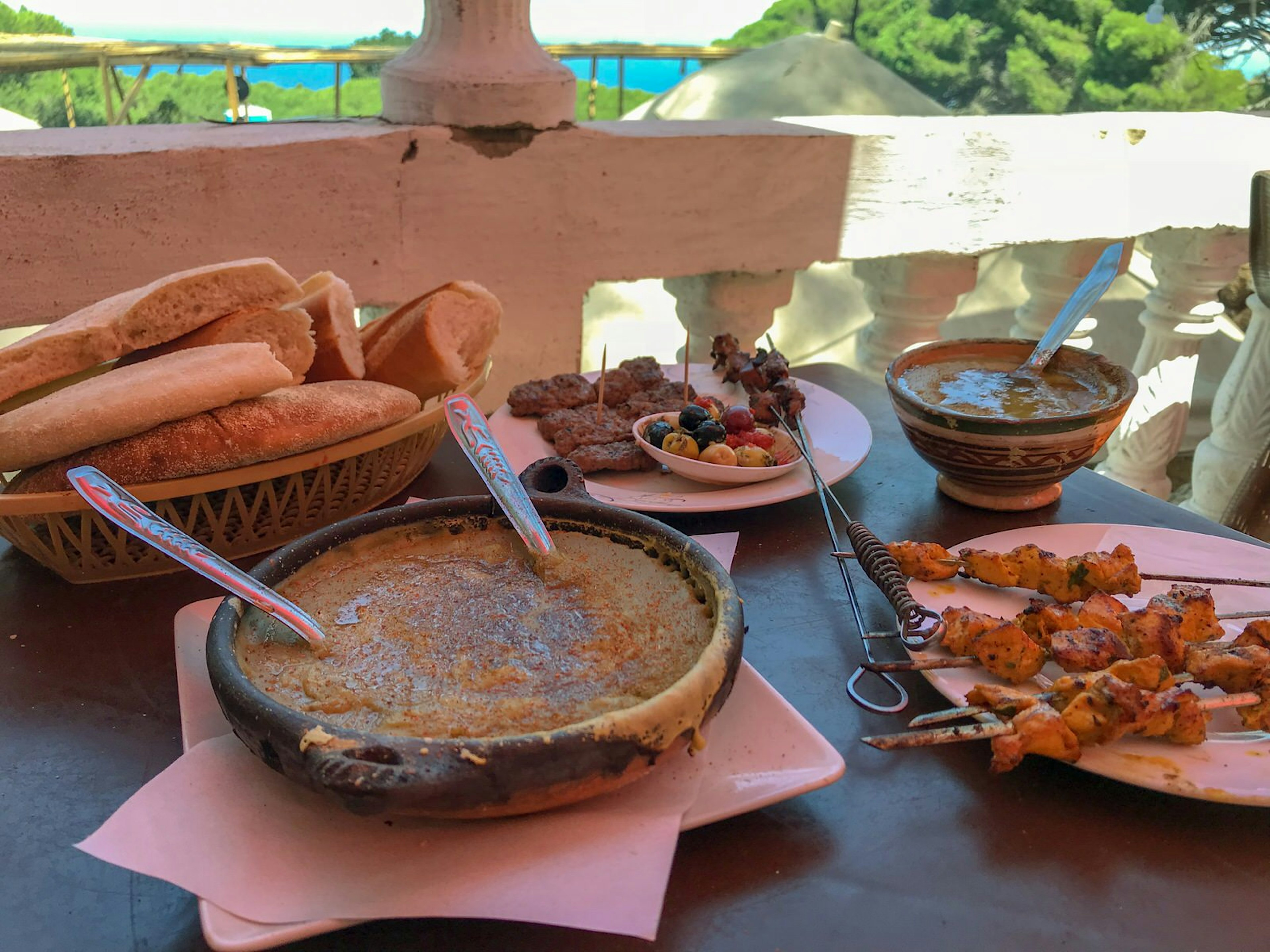 Meat skewers, bissara and bread on the table at Restaurant Domahana, Tangier, Morocco