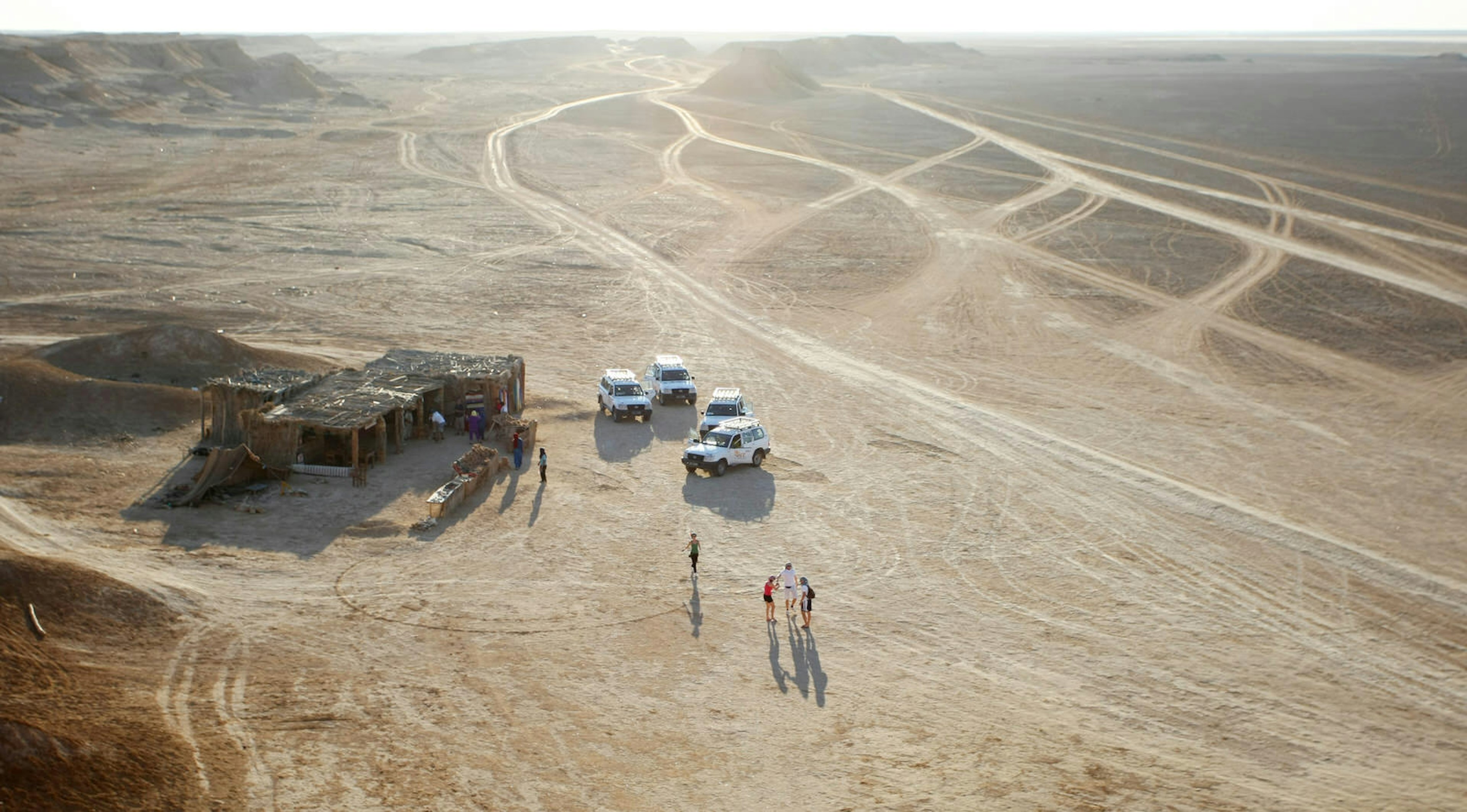 Tourists at the camel head rock, one of the tourist stops in Ong Jemel, Tozeur, Tunisia. Ong Jemel is the place near Tozeur, where the movies Star wars and the English Patient were filmed.