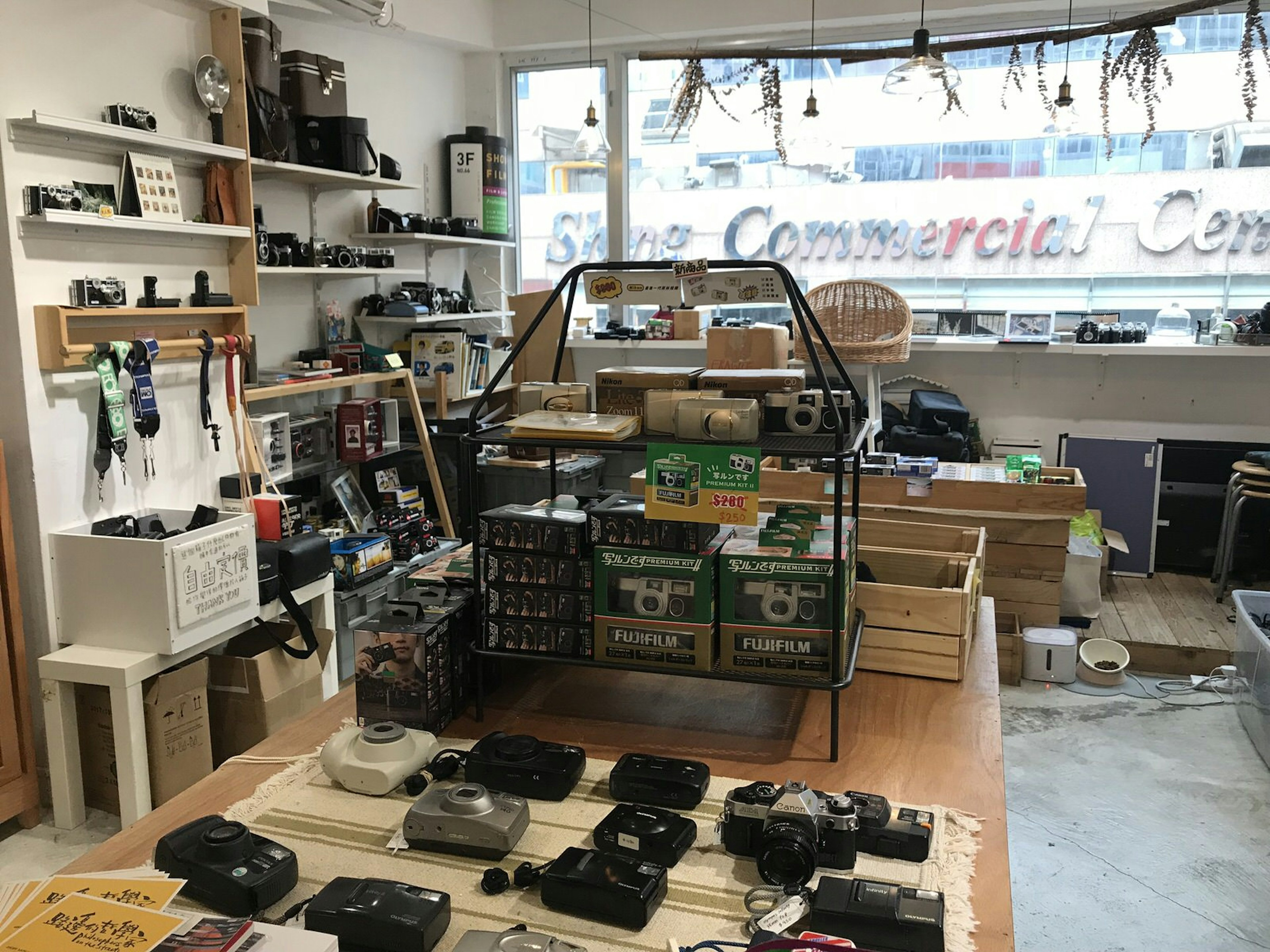 Tables and shelves full of cameras, camera equipment and film