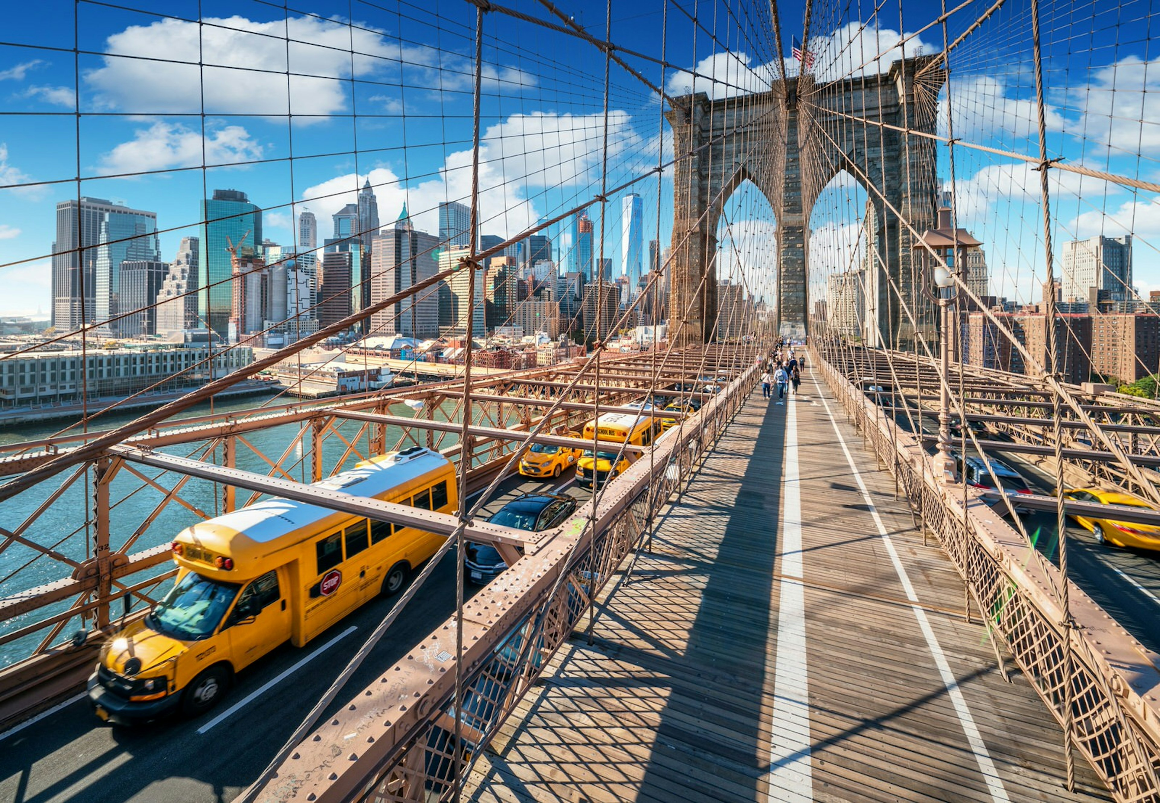 A shot of a bus travelling across the Brooklyn Bridge in New York