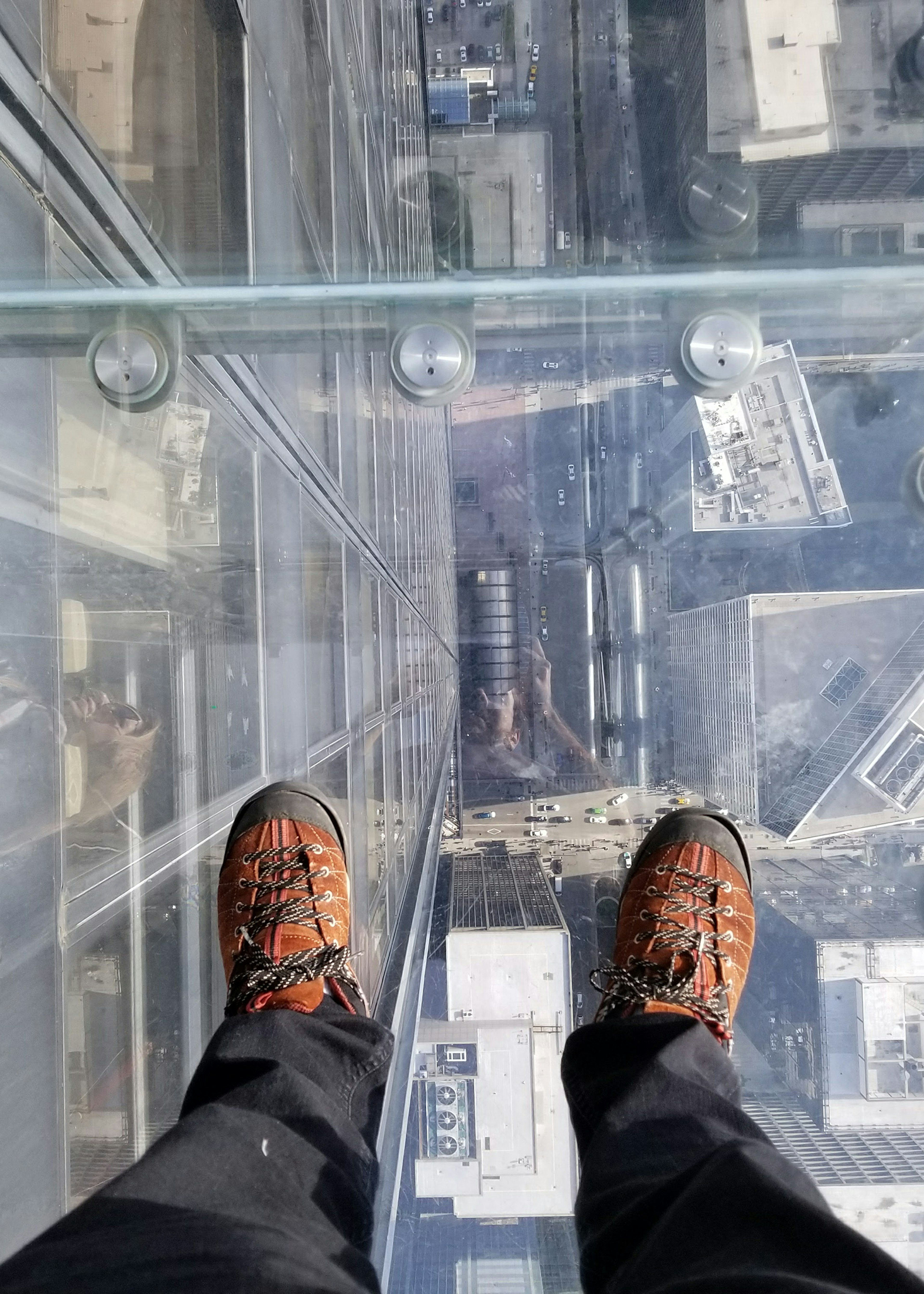 Feet on the glass balcony at the Skydeck of the Willis Tower, Chicago © Geraldo Ramos / Shutterstock