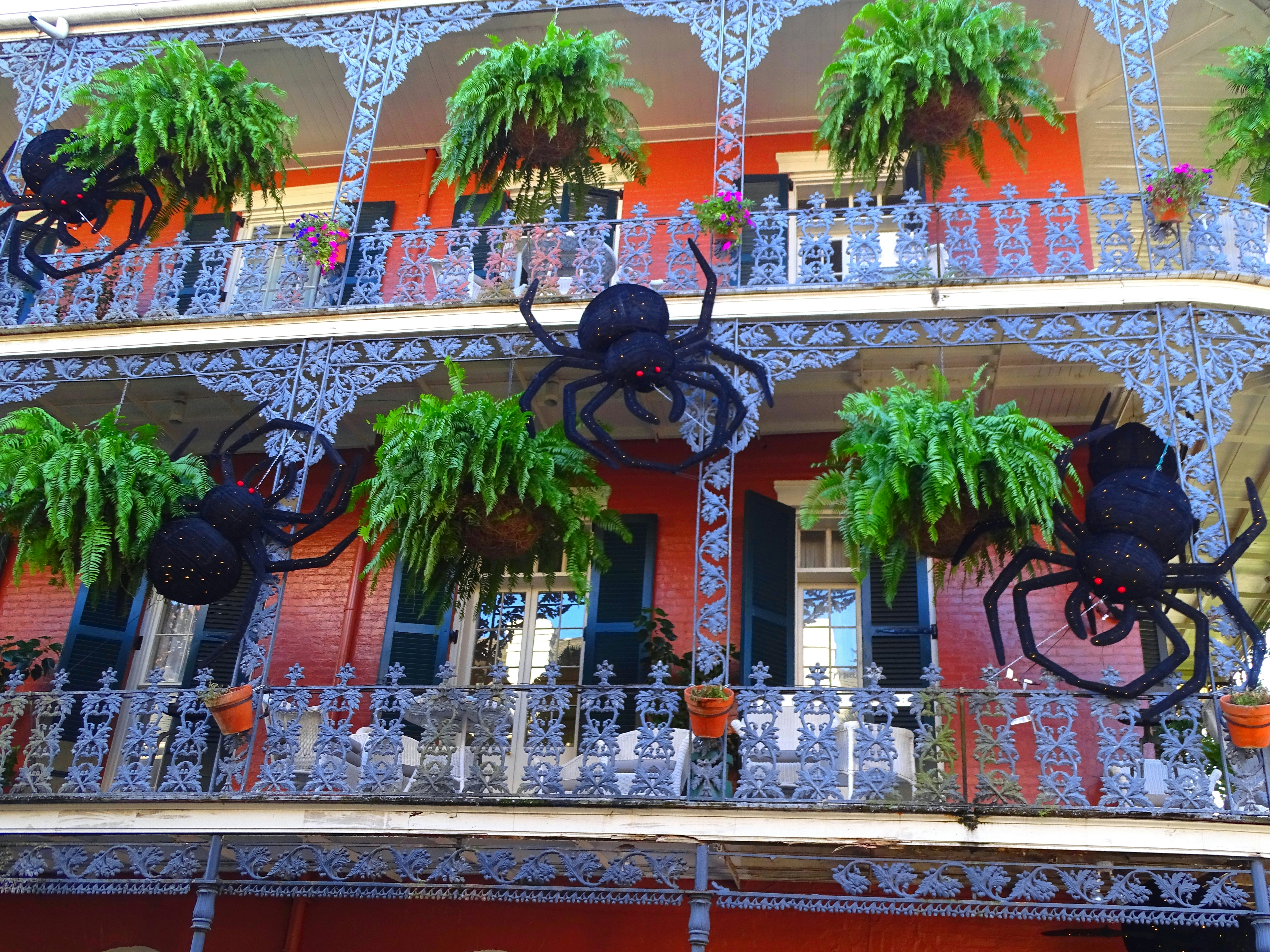 A wrough-iron balcony decorated with giant spiders to mark Halloween