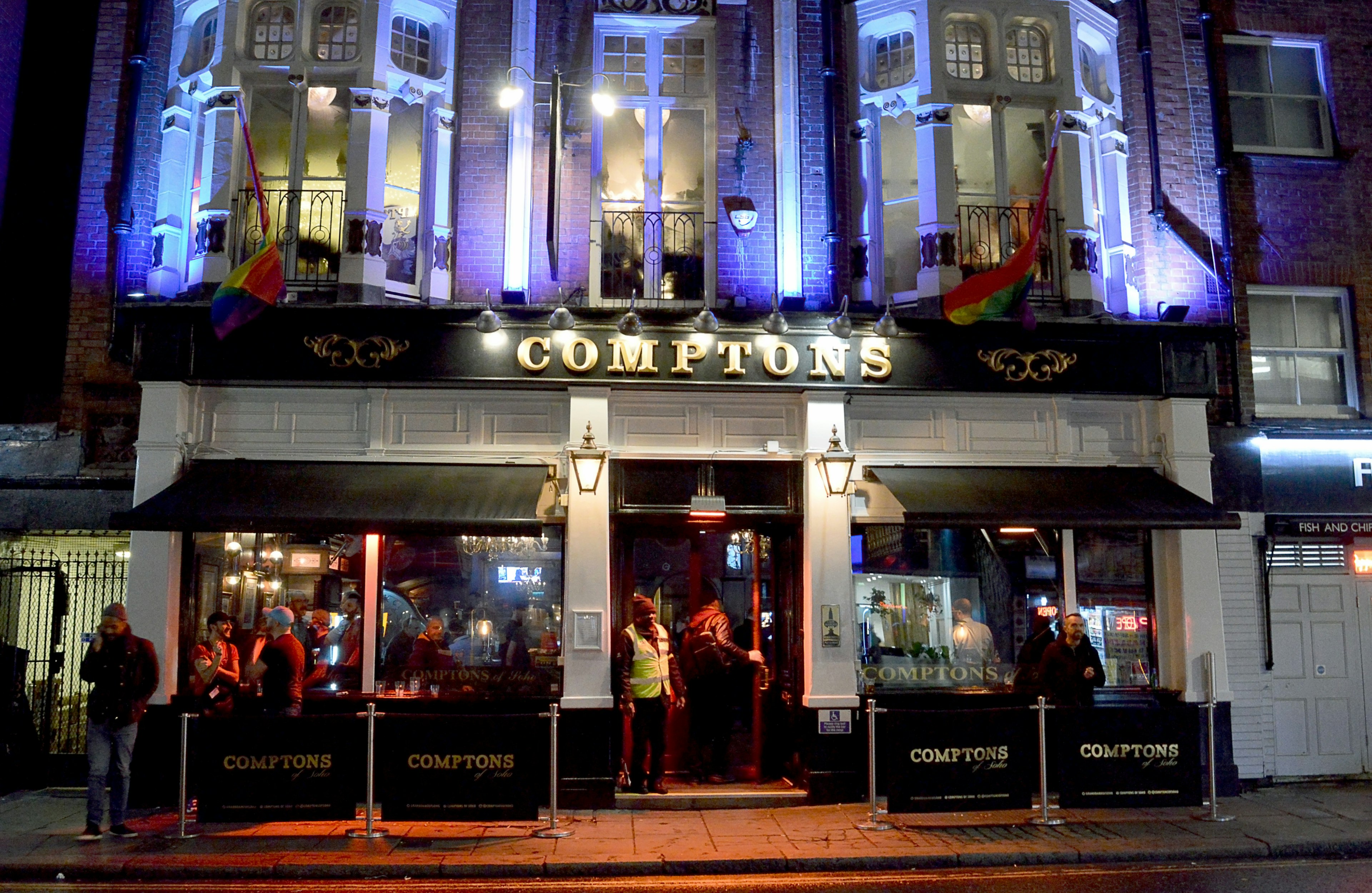 The facade of Comptons of Soho at night;