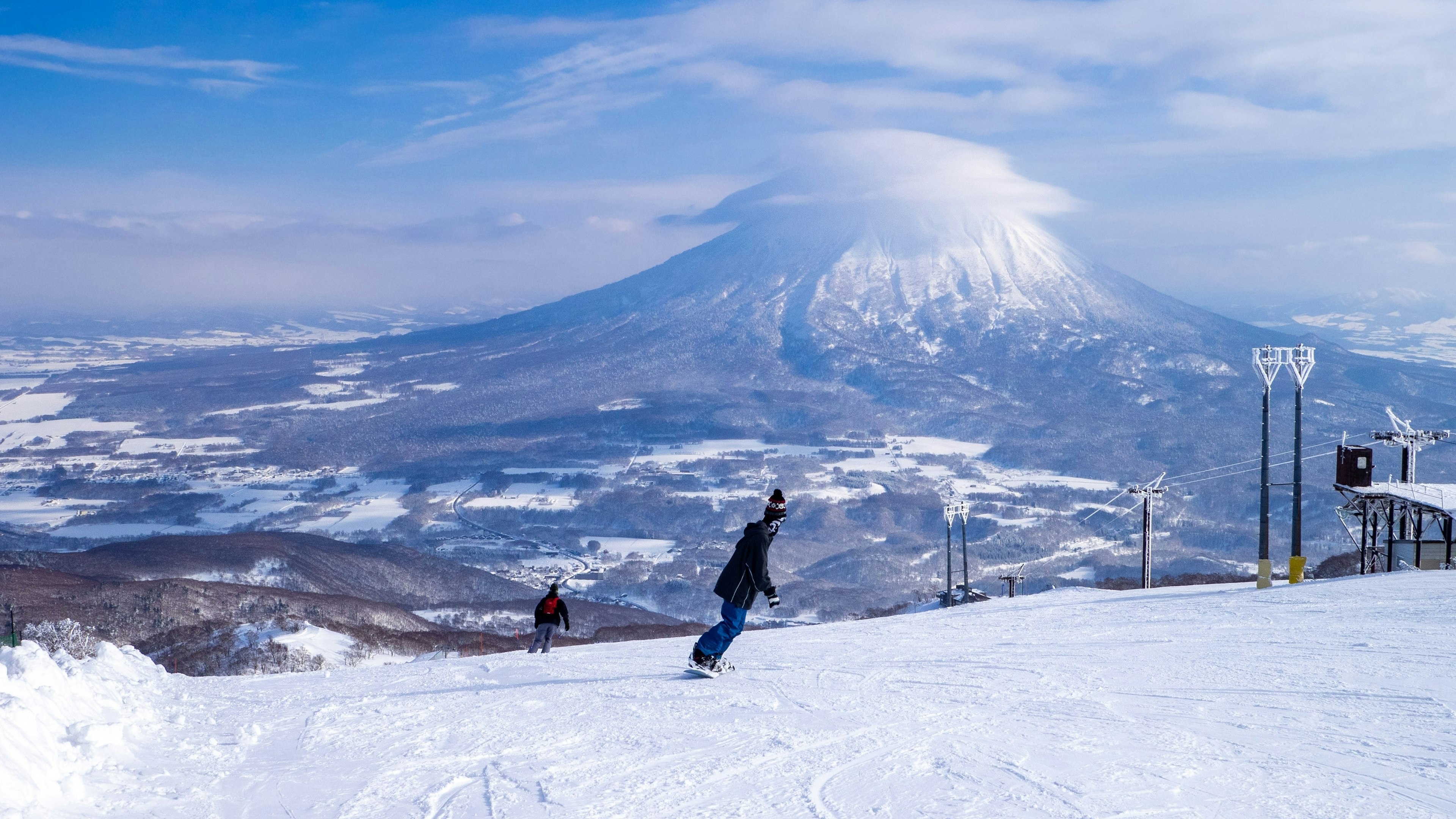 Snowy volcano with cap cloud viewed from a ski resort (Niseko, Hokkaido, Japan)