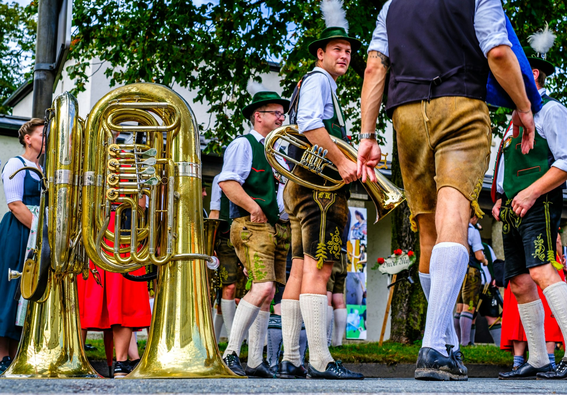 Participants wearing lederhosen and other traditional dress march in a parade for Herbstfest Rosenheim, Bavaria