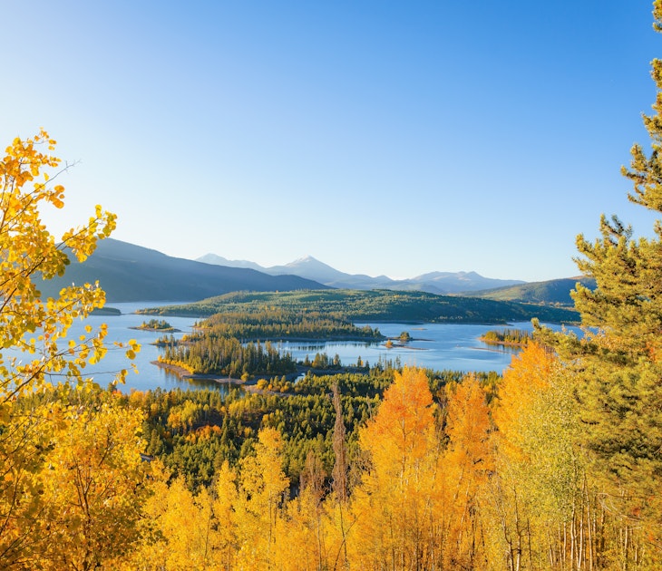 Yellow aspen trees with lakes and mountains in the background in Colorado