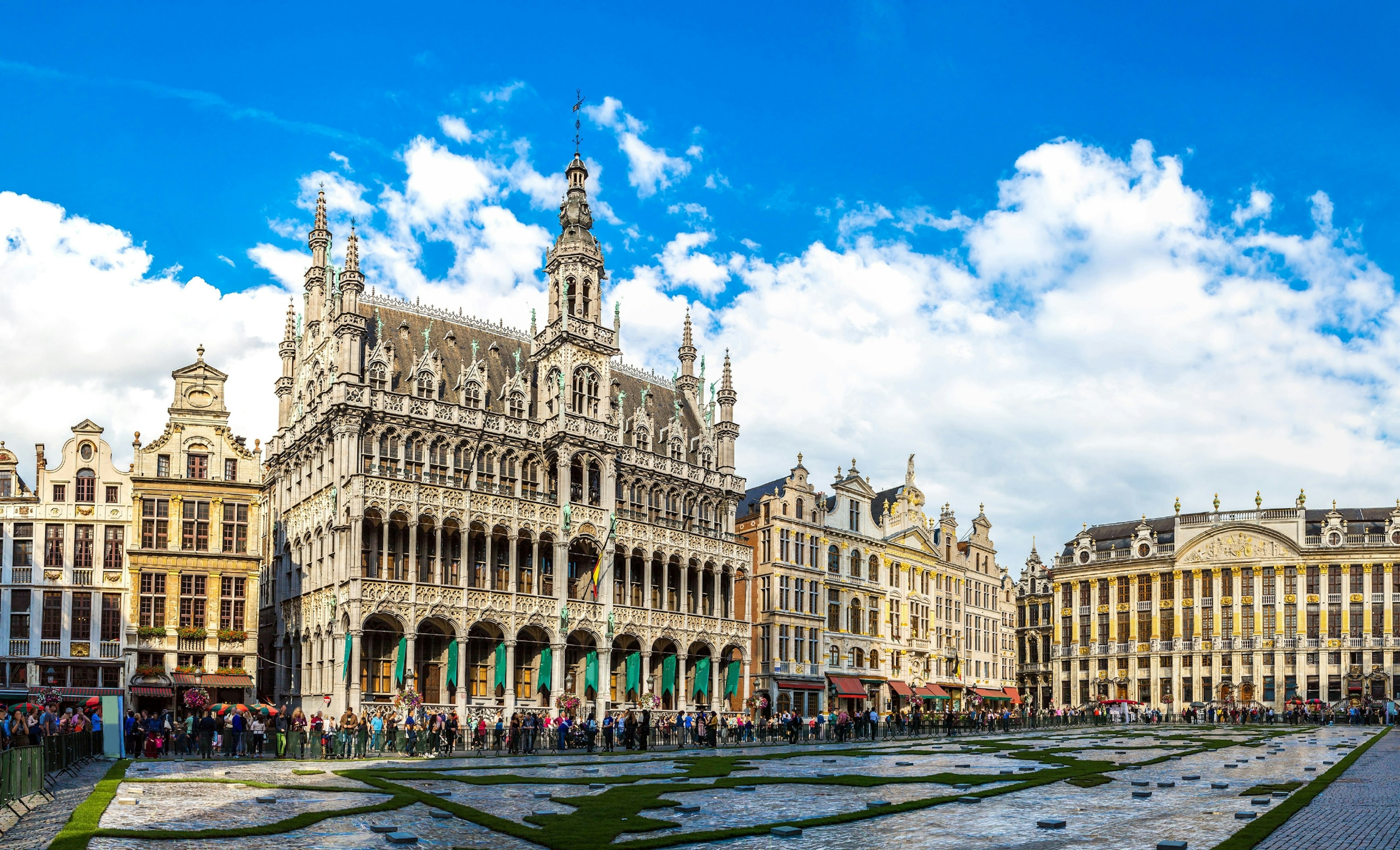 The Grand Place in a beautiful summer day in Brussels, Belgium.
architecture, background, beautiful, belgian, belgium, blue, brussel, bruxelles, building, capital, carpet, city, cityscape, day, europe, european, facade, famous, flower, grand, grote, hall, historic, history, house, landmark, main, market, markt, monument, old, panorama, panoramic, people, place, scenic, sculpture, sky, square, statue, summer, tourism, tourist, tower, town, travel, unesco, urban, vintage