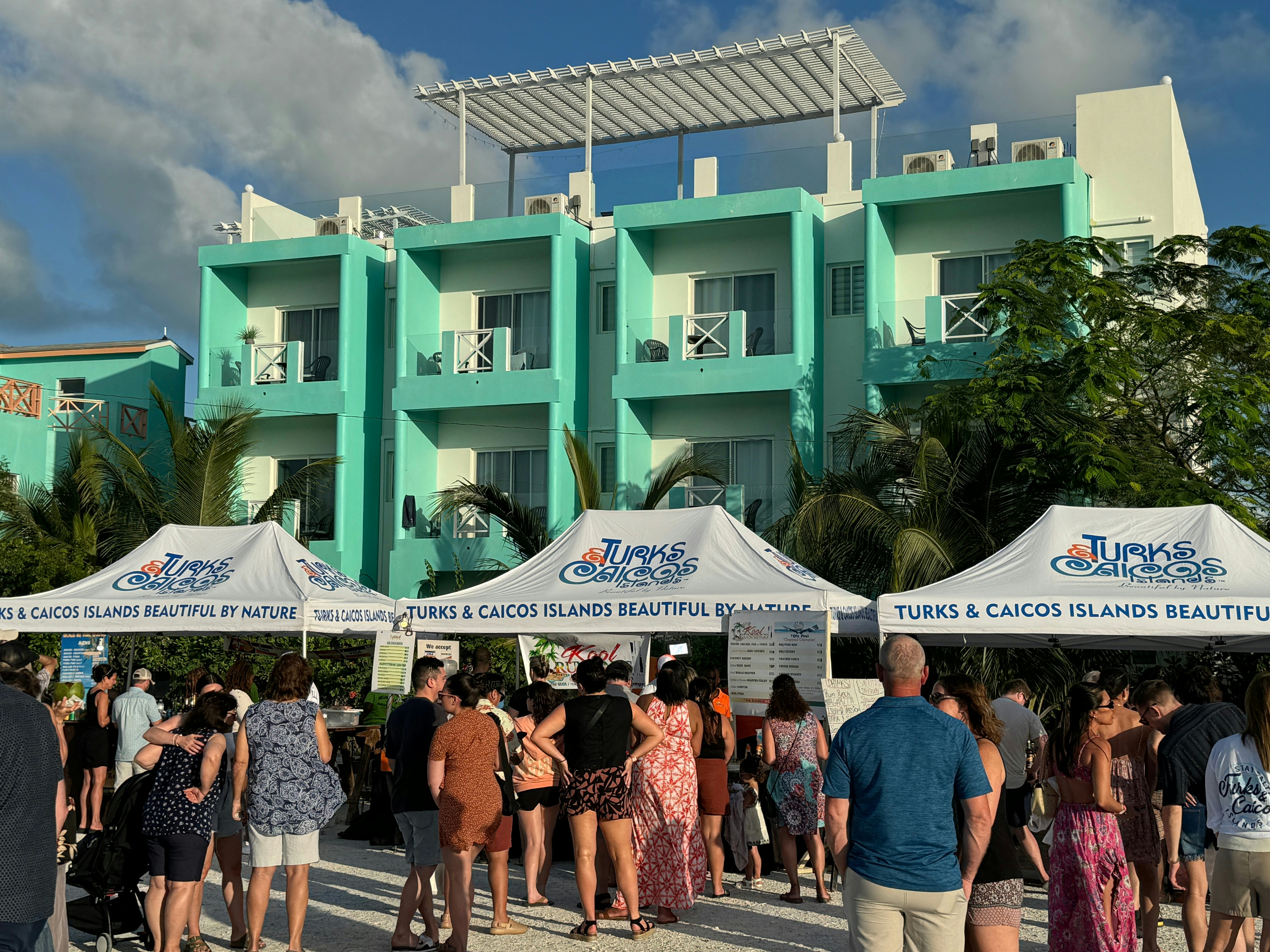 Many people line up in front of food stalls at the Thursday Fish Fry event on Providenciales, Turks and Caicos. | Work up an appetite and head to the Thursday Fish Fry event on Providenciales. Ritu Manoj Jethani/Shutterstock