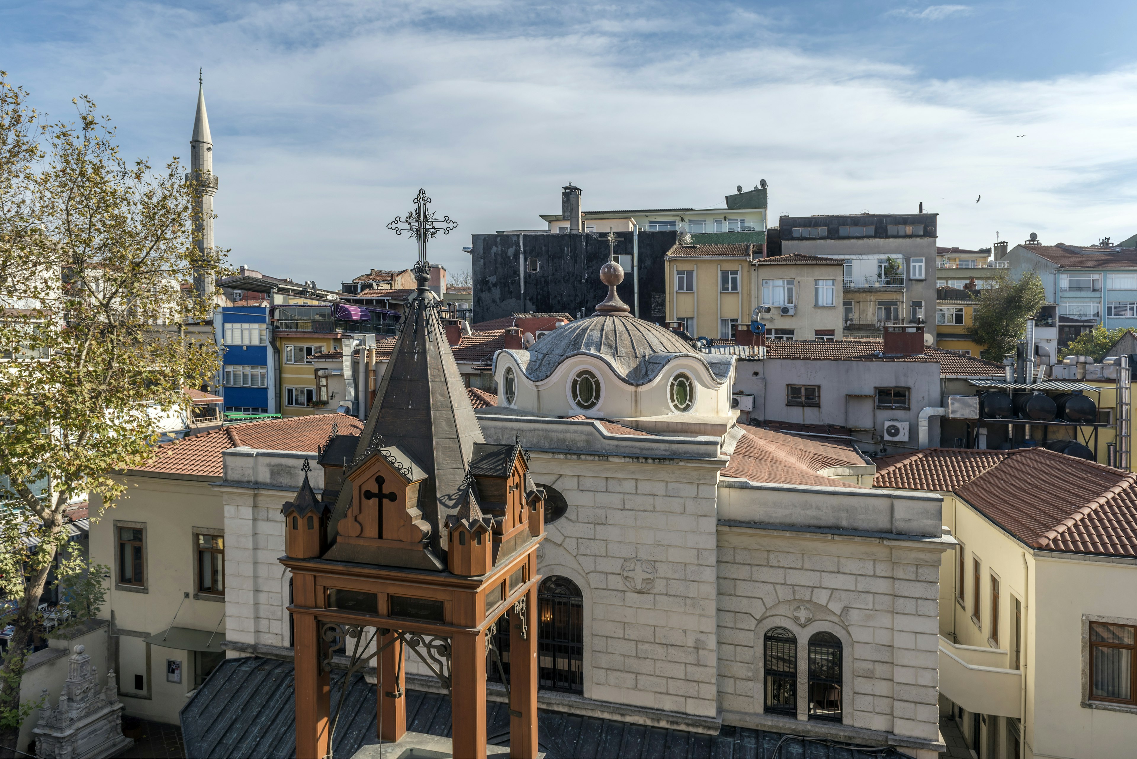 A shot across the rooftops. A church is in the foreground, with a minaret in the distance