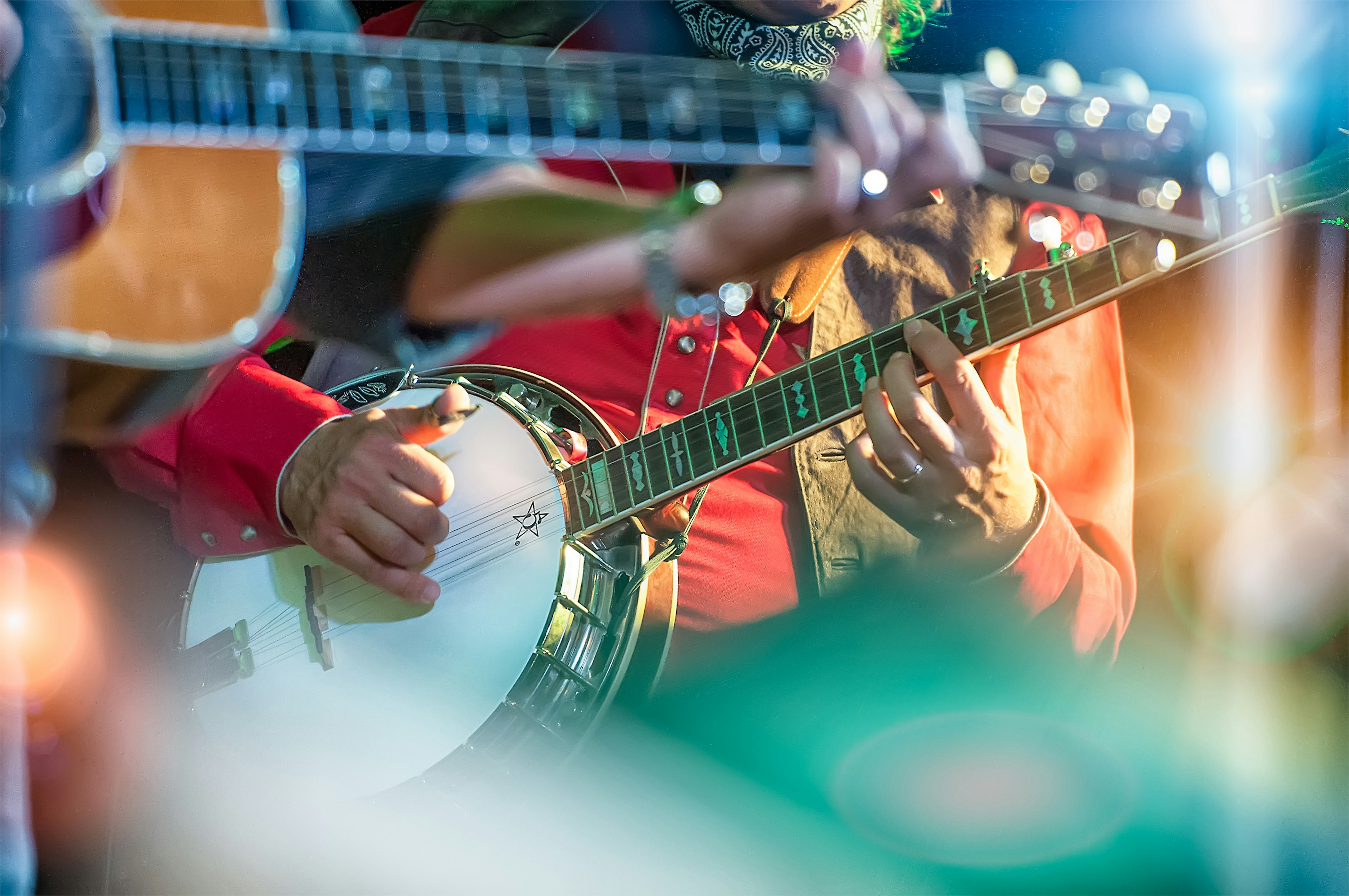 A close-up of someone playing in banjo in traditional Western wear. Nashville.