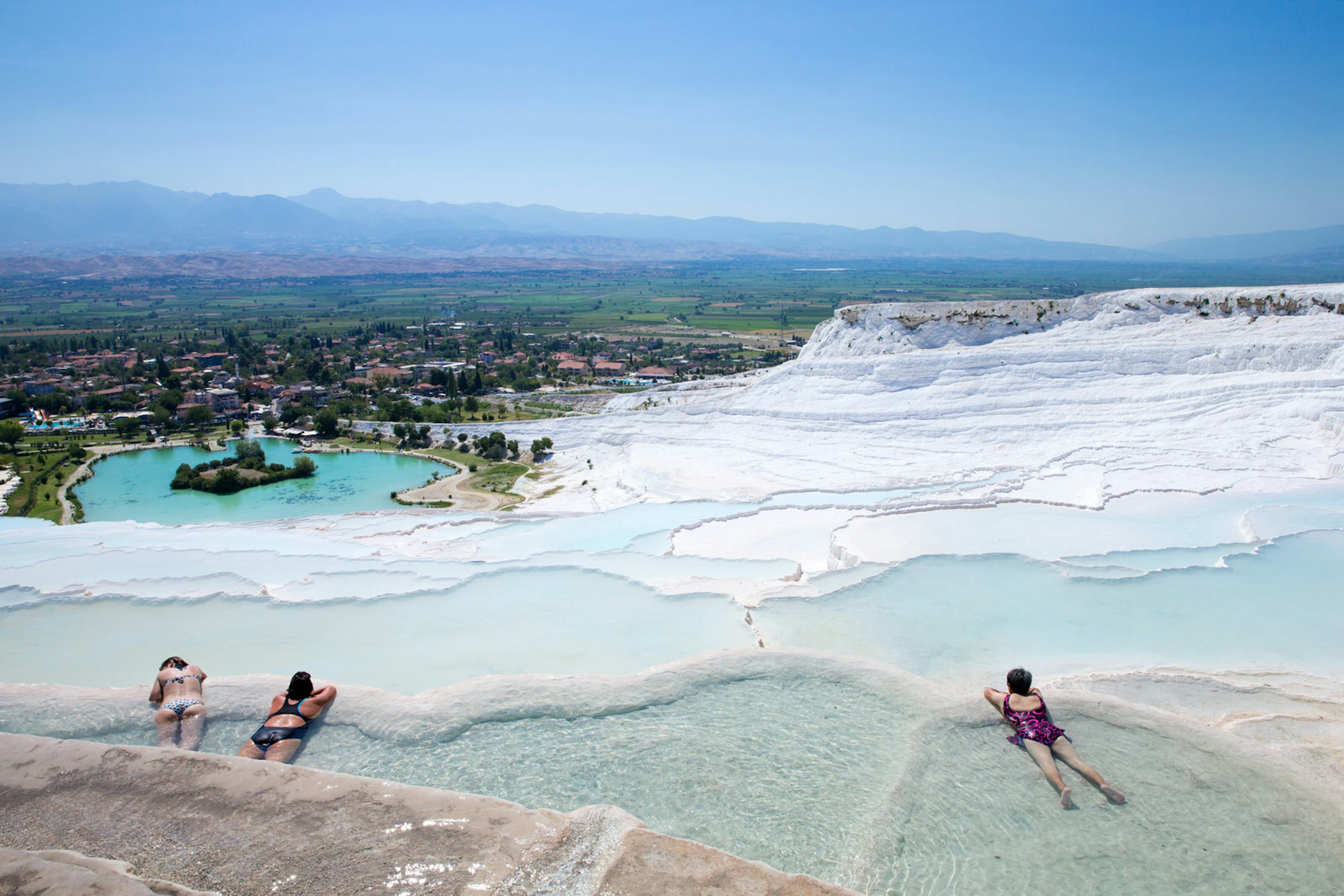 Bathers relaxing in Pamukkale terraced hot springs in Turkey