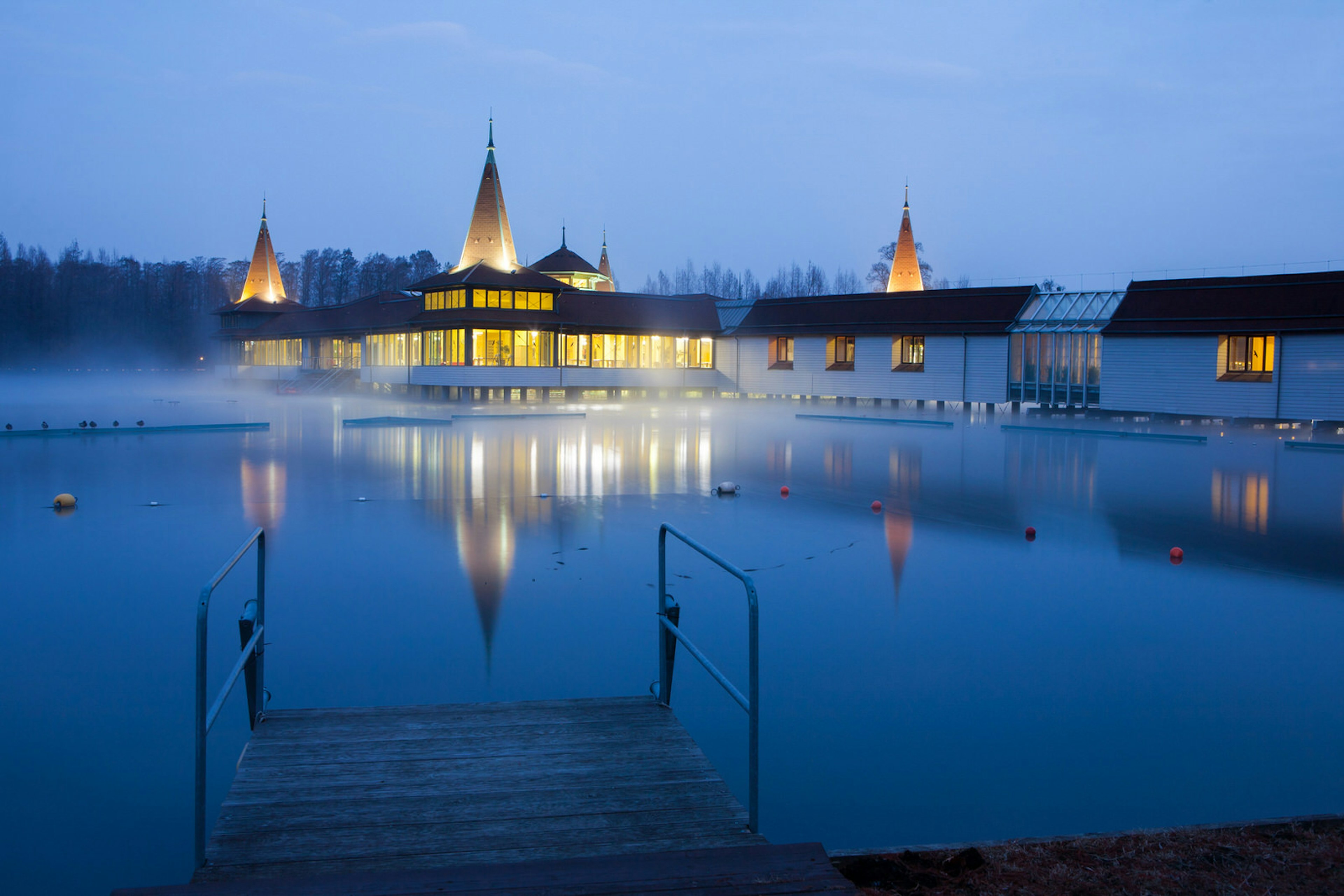 Heviz Lake at night with the on-site spa visible in the background