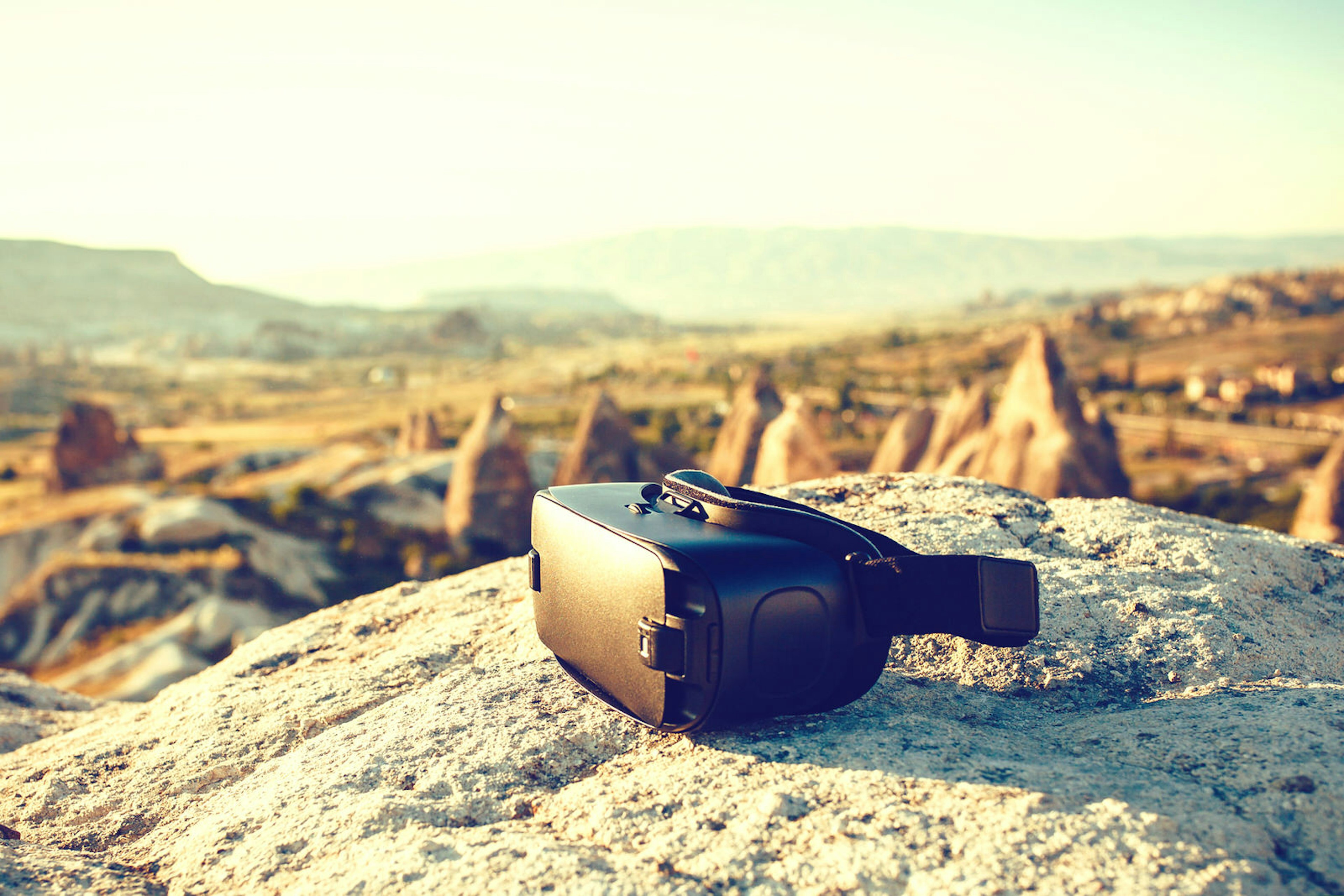 A virtual reality headset in a rocky landscape