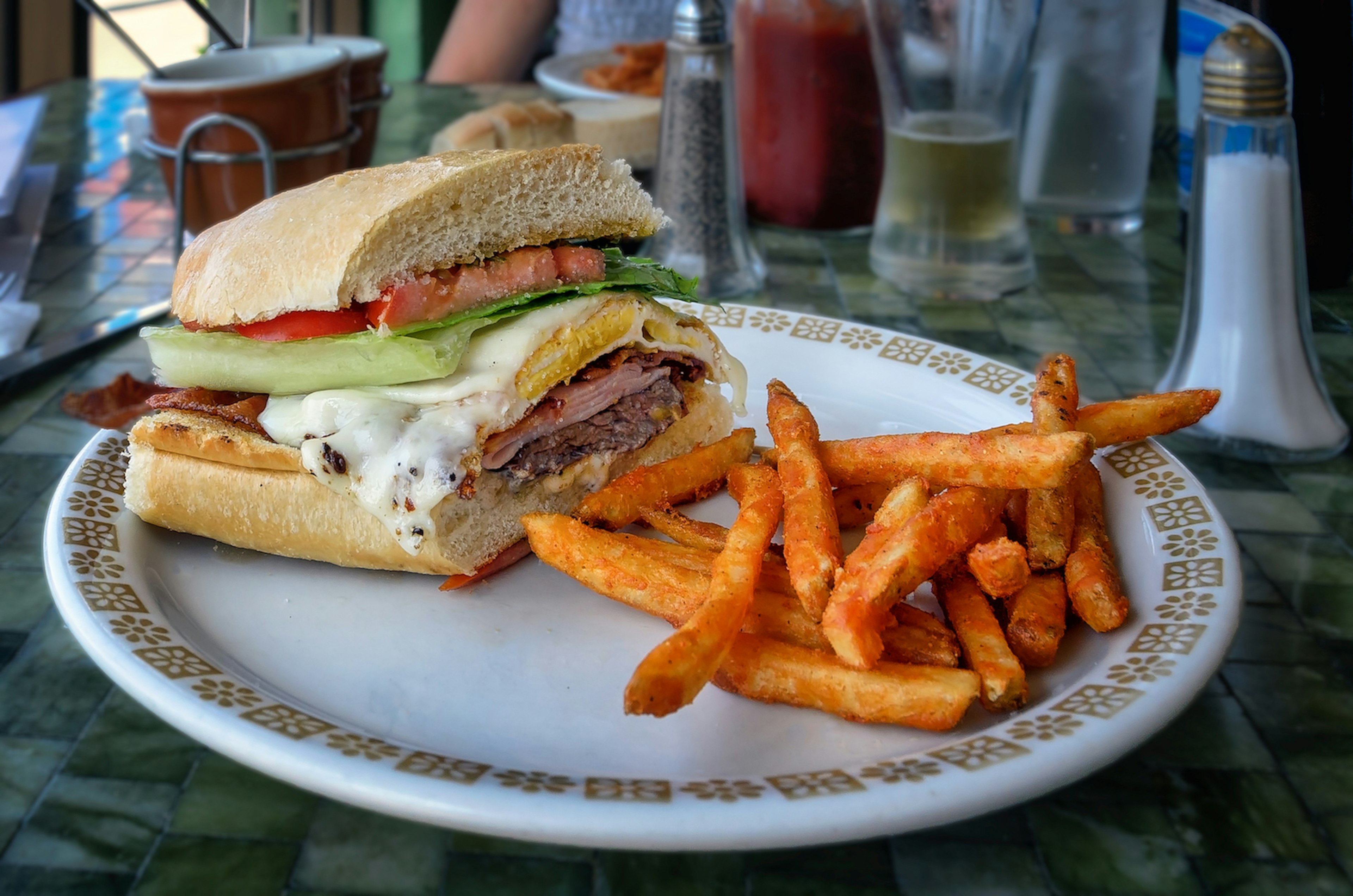 A chivito sandwich with fries