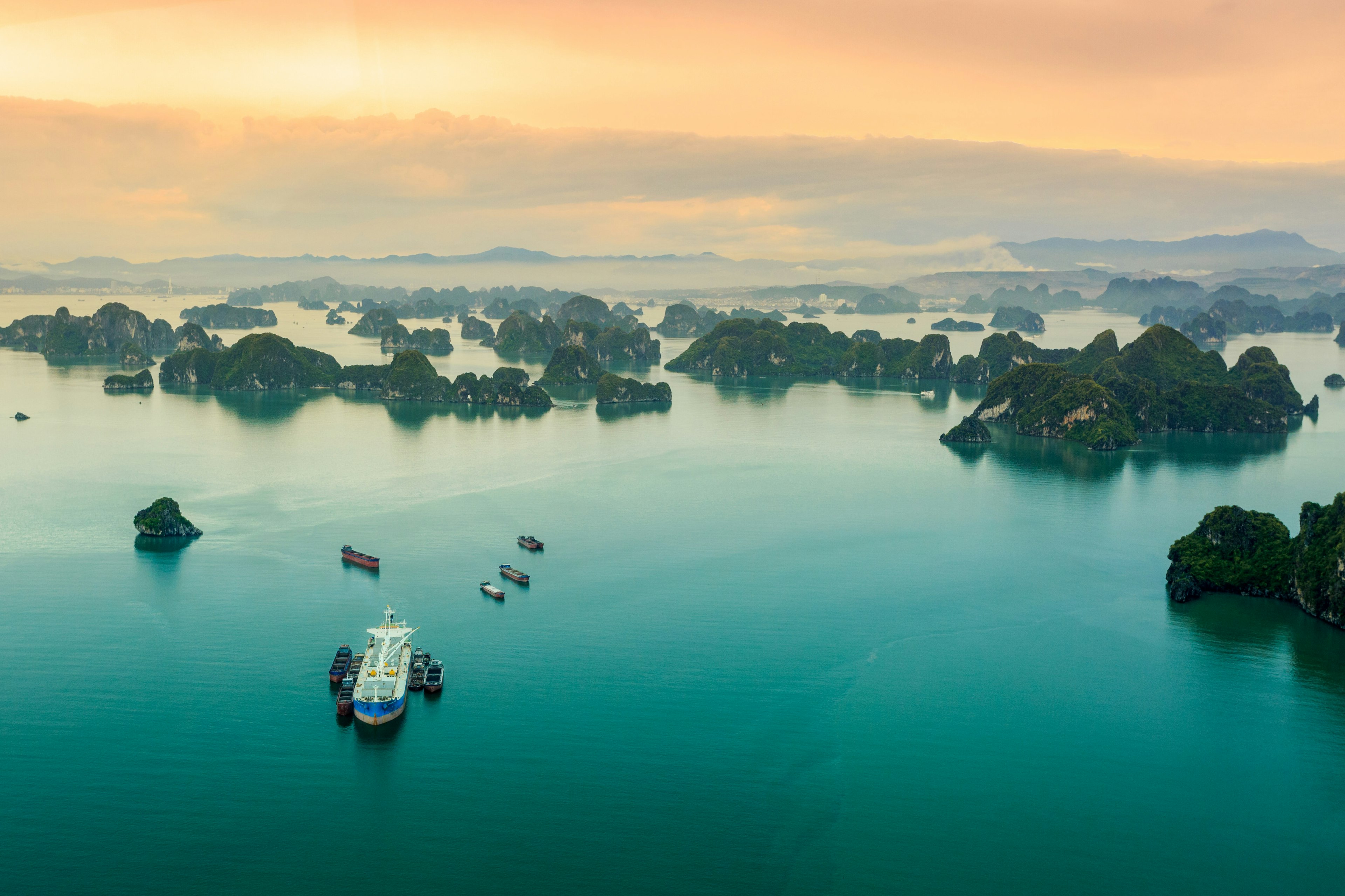 Many islets stretch into the distance of the ocean reflecting the sunlight, viewed from a seaplane