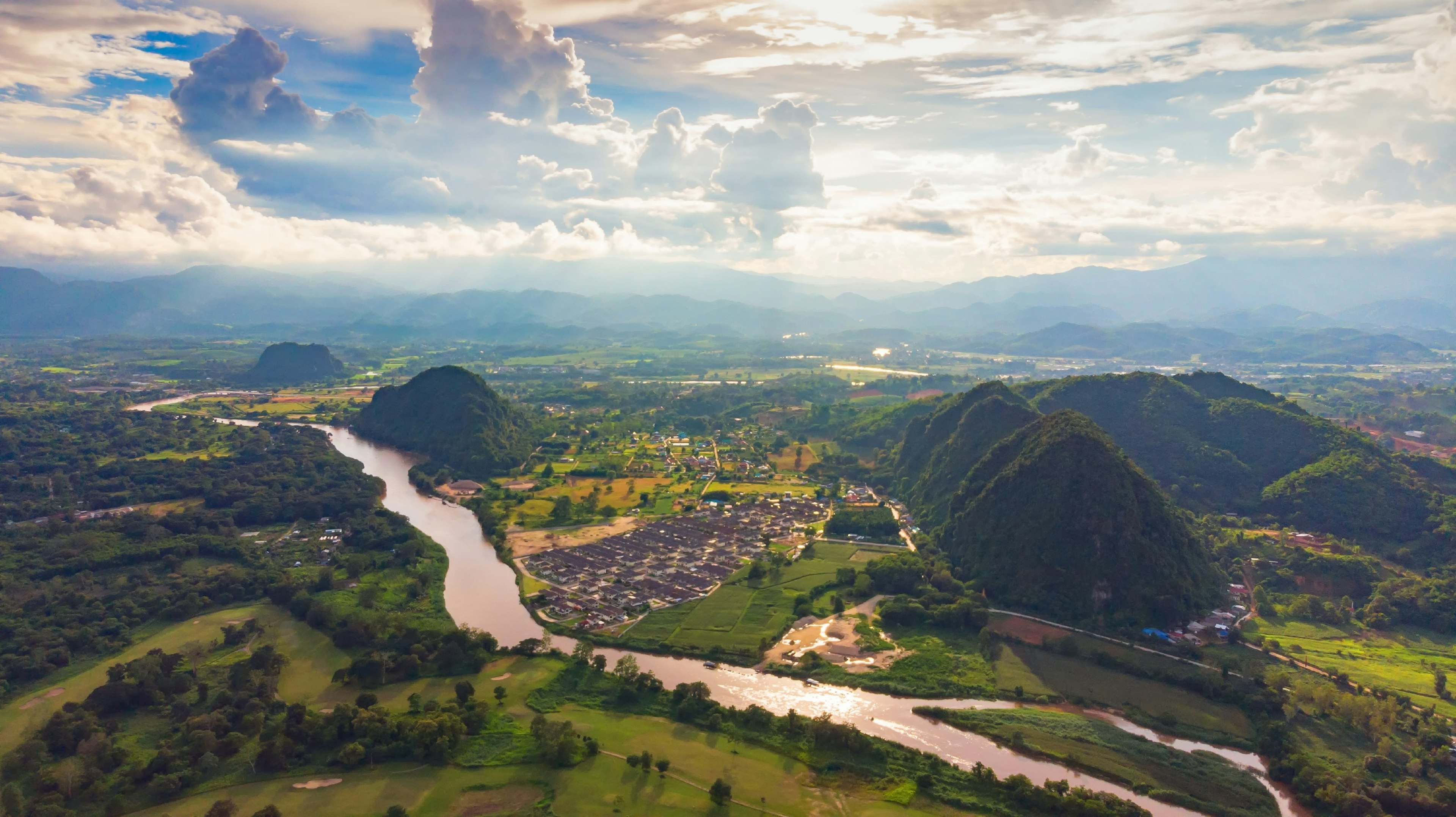 Aerial view of city nestled in lush greenery.jpg