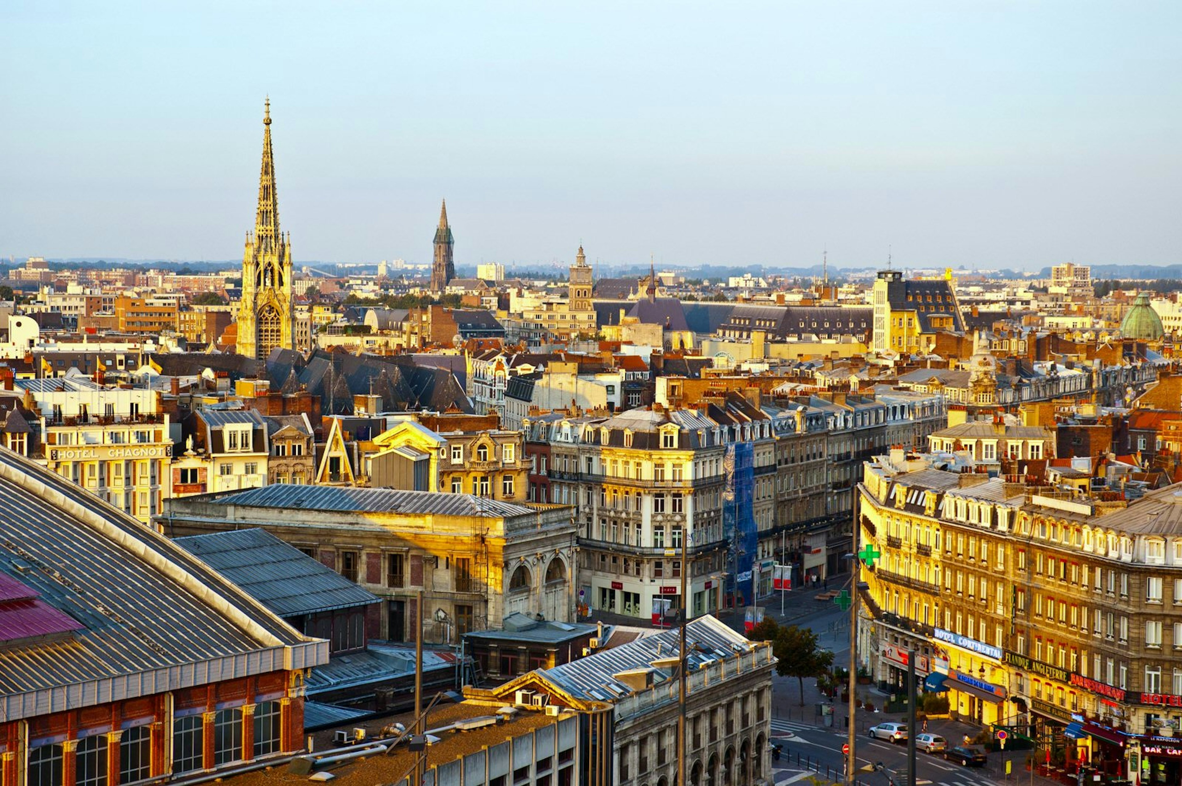 The sun glows on rooftops, spires and the facades of Lille's buildings during the late afternoon