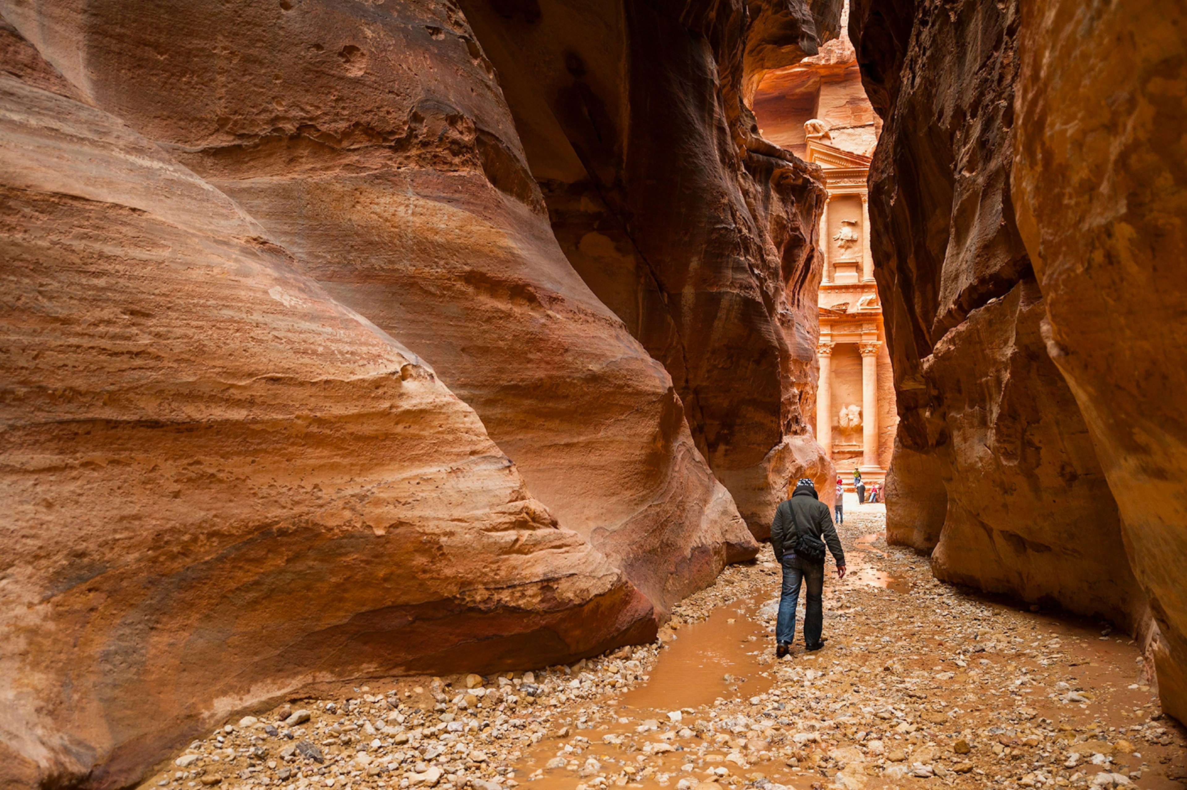 A lone tourist walking through the Siq, Petra © Yongyut Kumsri / Shutterstock